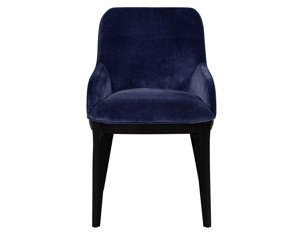 Set of 10 custom Navy velvet modern dining chairs. Featuring modern contoured curved backs with sculpted legs in an ebonized finish. Set includes 8 side chairs and 2 armchairs.

Price includes complimentary scheduled curb side delivery to the