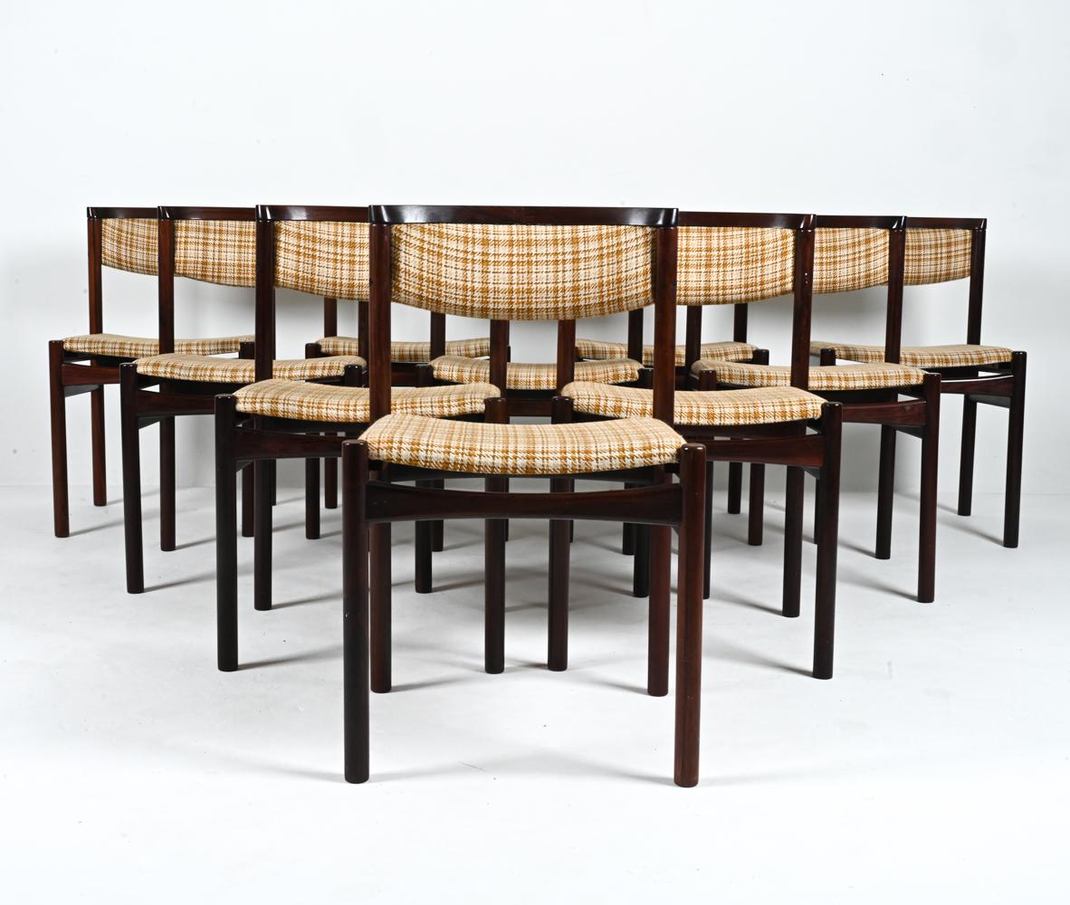 Unveiling a truly remarkable set of (10) dining side chairs in solid rosewood, a testament to Danish craftsmanship at its zenith. Crafted in the 1960's by SAX (Saxkjobing Savvaerk Stolefabrik), these chairs are a harmonious fusion of design