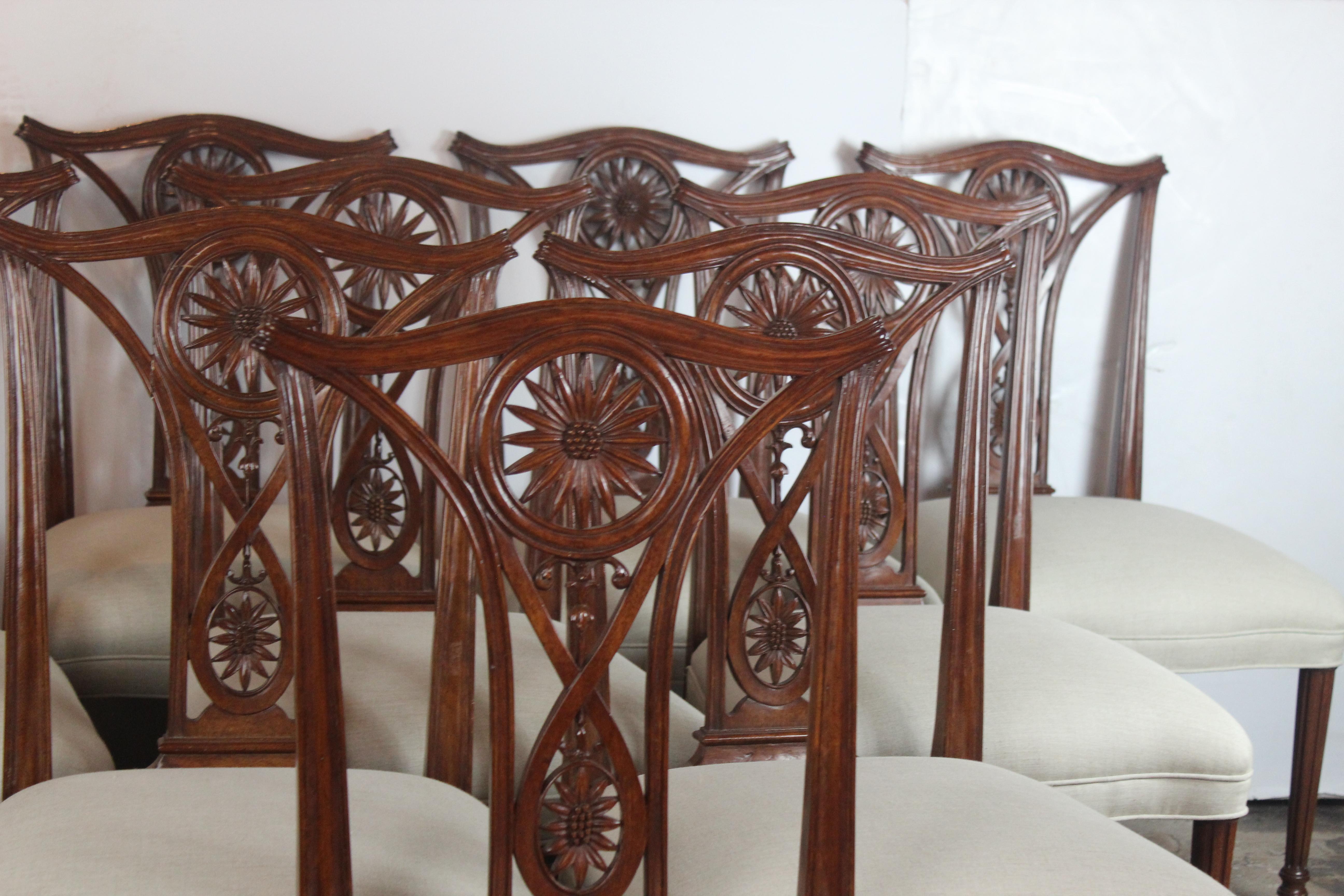 Wonderful quality set of ten dining chairs. The frame is mahogany wood carved in sunflower pattern and the legs are simple straight. The seat is covered in linen.
