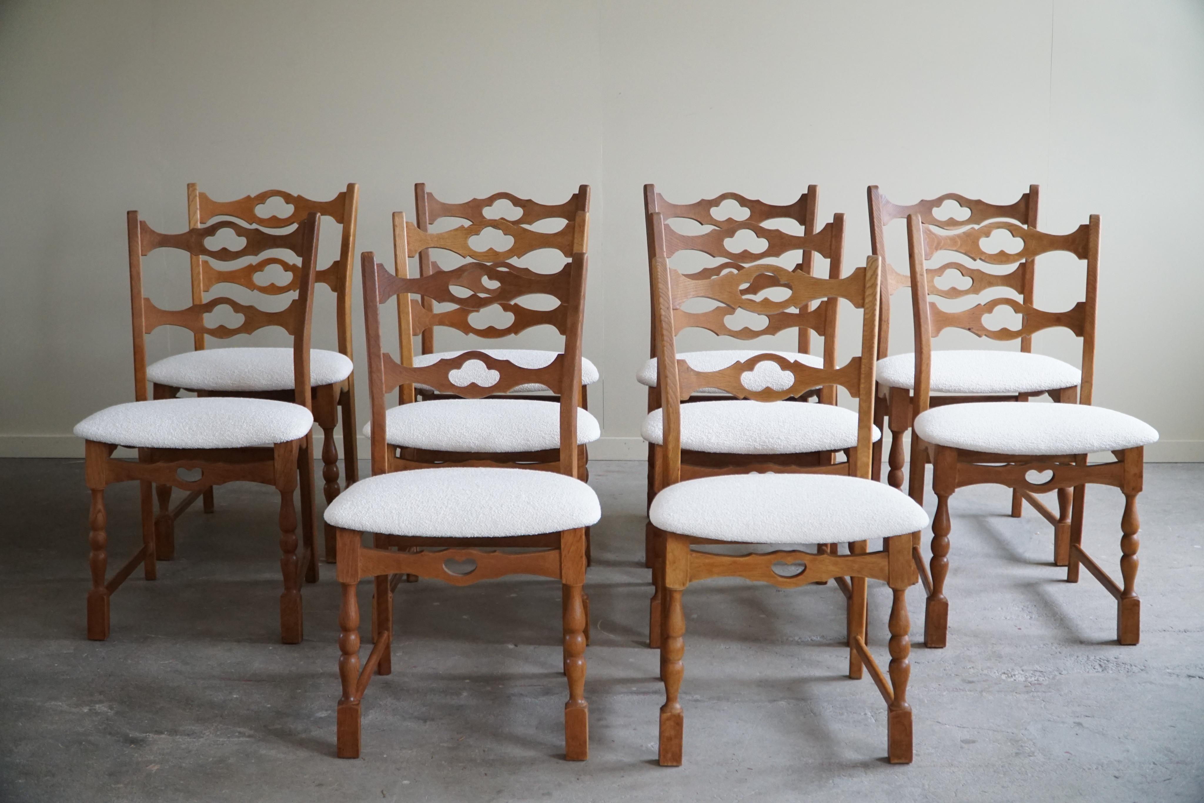 A sculptural classic set of 10 dining chairs in oak, seats reupholstered in white bouclé. 
Attributed to Henning (Henry) Kjærnulf for E.G. Møbler - ca 1960s.

The overall impression of these mid century chairs are really good.
These modern chairs