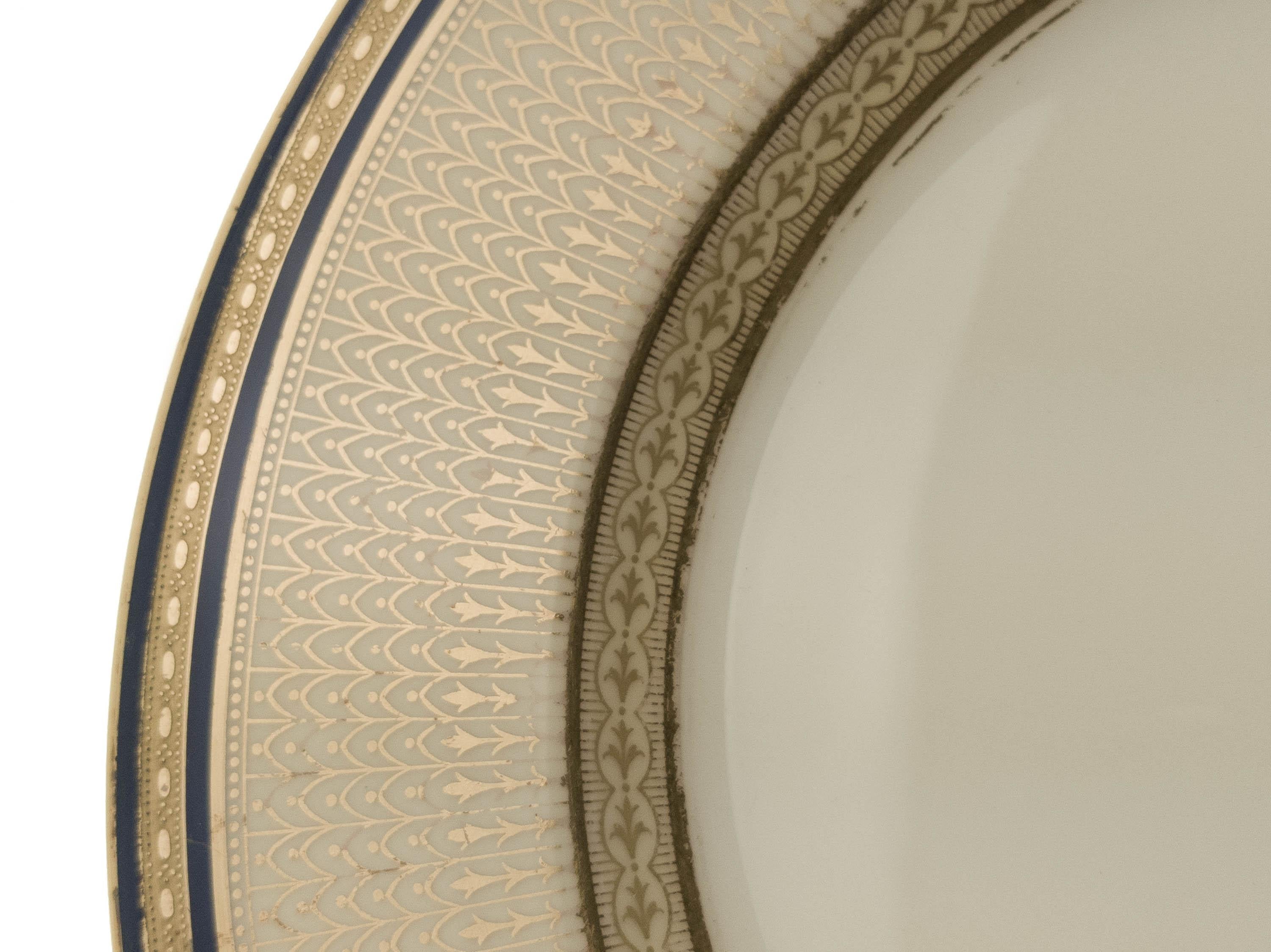 A Classic traditional set of dinner plates by one of America's premier fanctories, Lenox. Custom ordered through the fine gilded age retailer of Wiss & Sons. These plates feature a double band of rich cobalt blue and an interesting mix