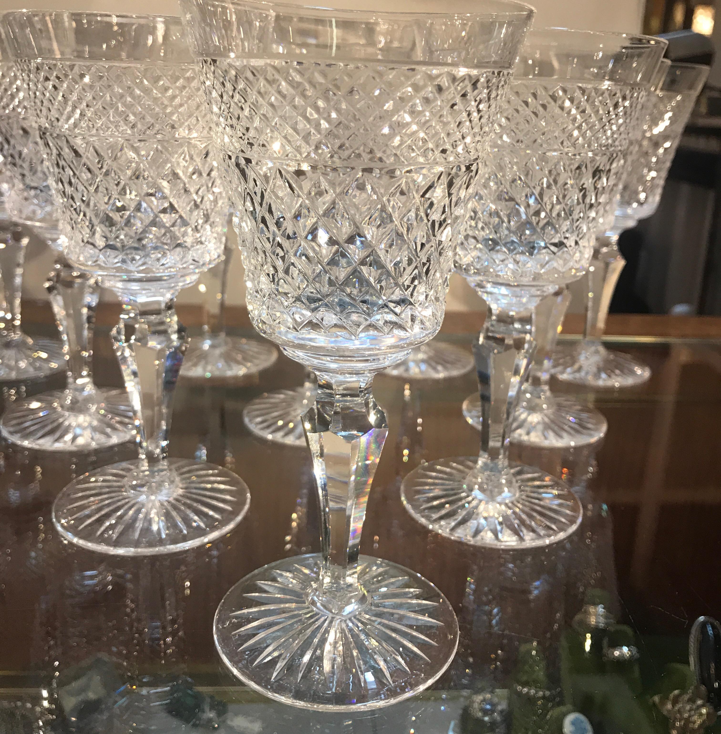 Elegant Edwardian style set of English wine stems by Royal Doulton. The Classic diamond cut bowls with panel cut stems and starburst bases. These are the retired Carylye pattern, in perfect condition. Measuring: 6 3/8 inches tall.