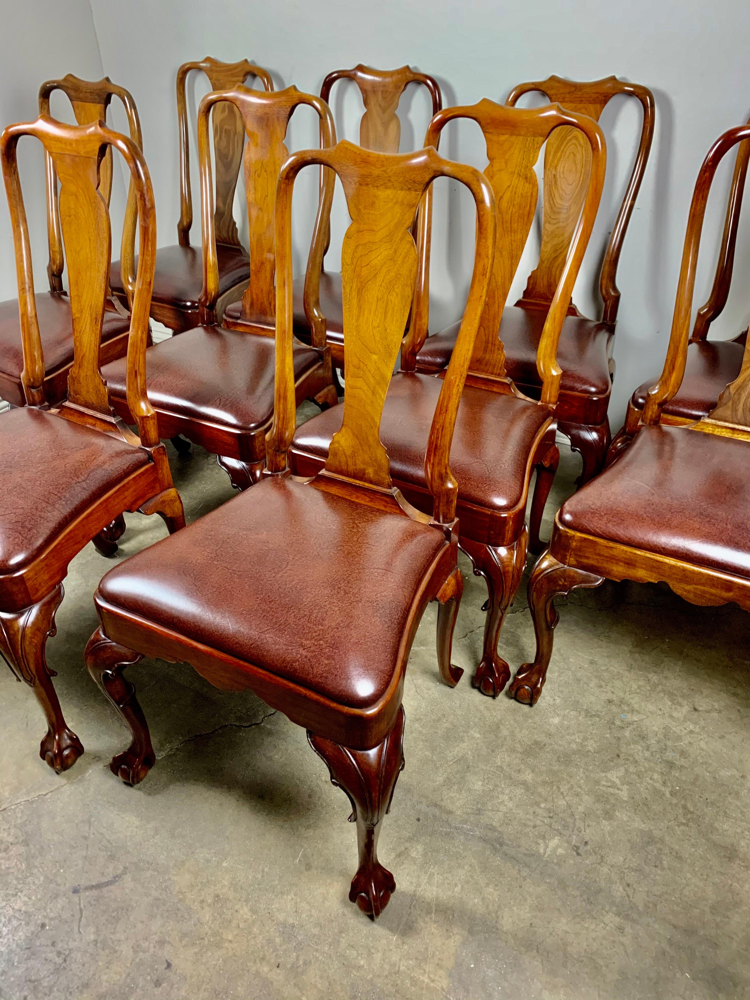 Set of (10) English Queen Anne style side chairs with cabriole legs and ball & claw feet. The chairs are upholstered in a chestnut colored brown faux leather covering.