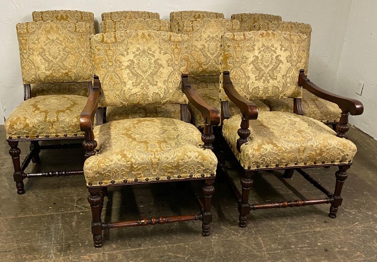 Set of 10 vintage Regency style dining chairs, 8 sides and 2 arm chairs. The armchairs have scrolled arm resting on turned supports. The frames have a generous seating and back rest area with impressive detail supported by tapered turned legs and