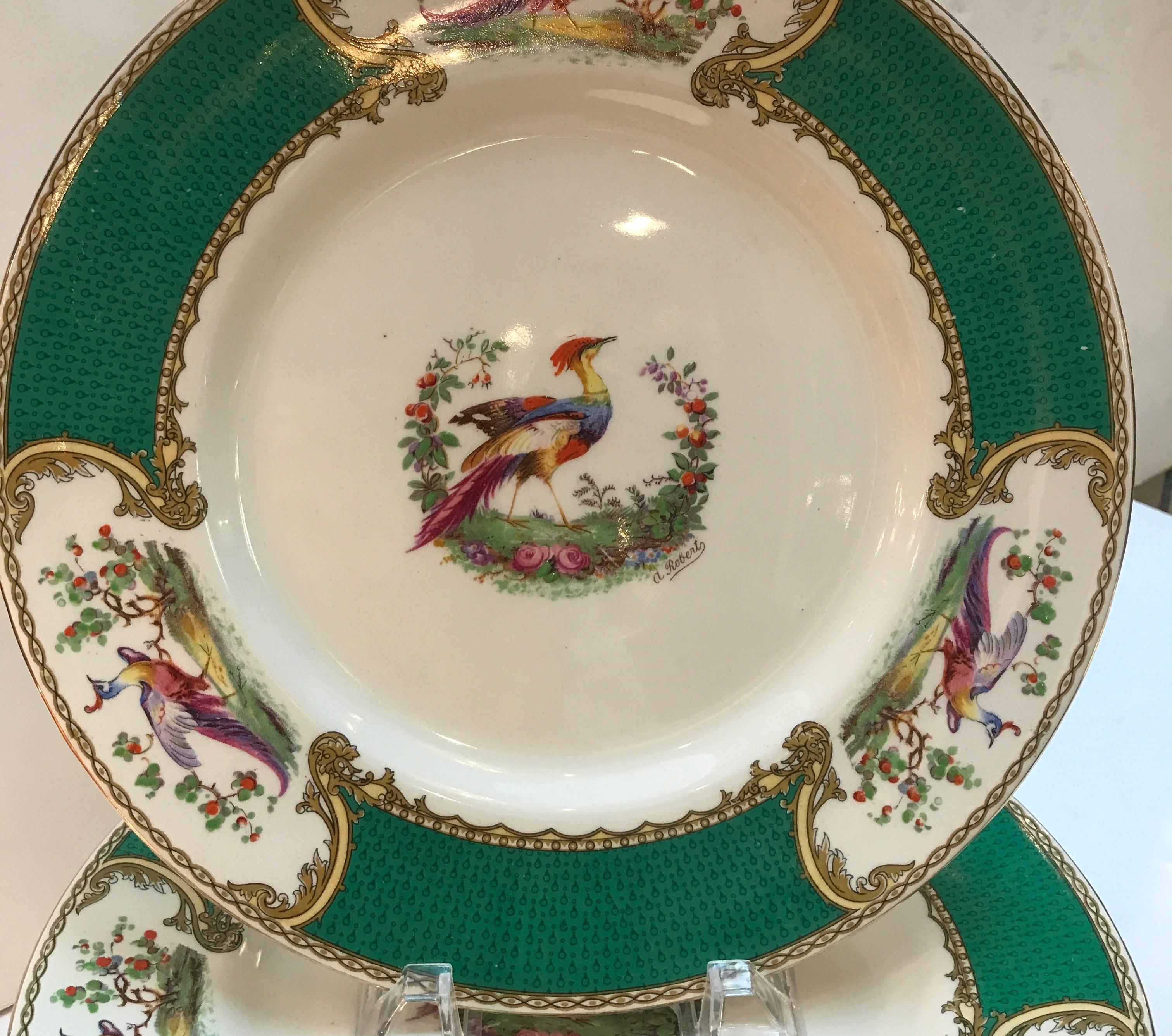 A set of ten Myott English Staffordshire plates in the Chelsea bird pattern. The plates are 10.75 inches in diameter, with hand painted floral and bird decoration in the 18th century style of Chelsea bird. The off white background with vibrant green