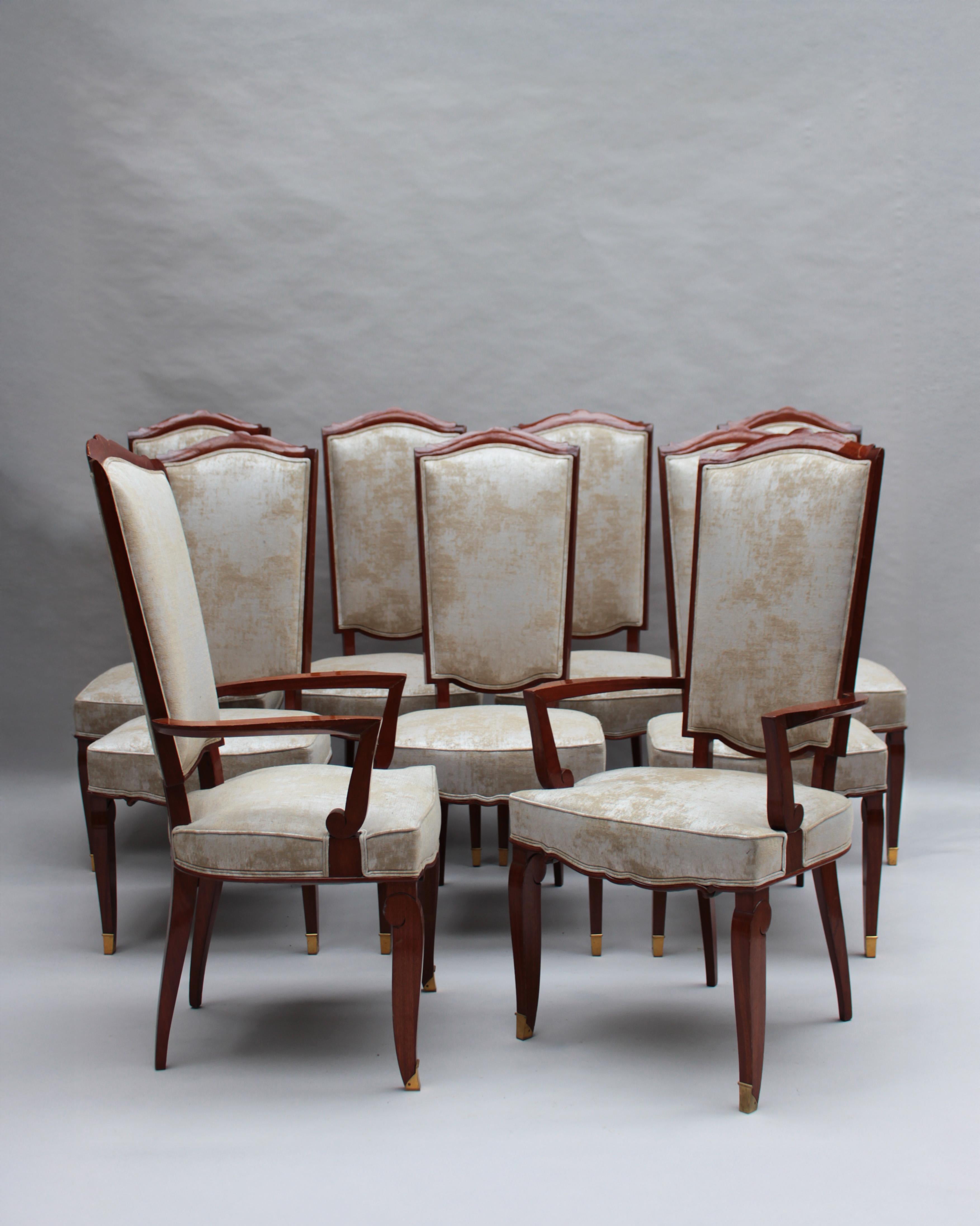 A set of ten fine French Art Deco dining chairs (eight side and two arm), in mahogany with bronze sabots. 
Designed by Jules Leleu for the Palais de l'Elysee in 1947

Documentation:  Same chairs represented in the book  