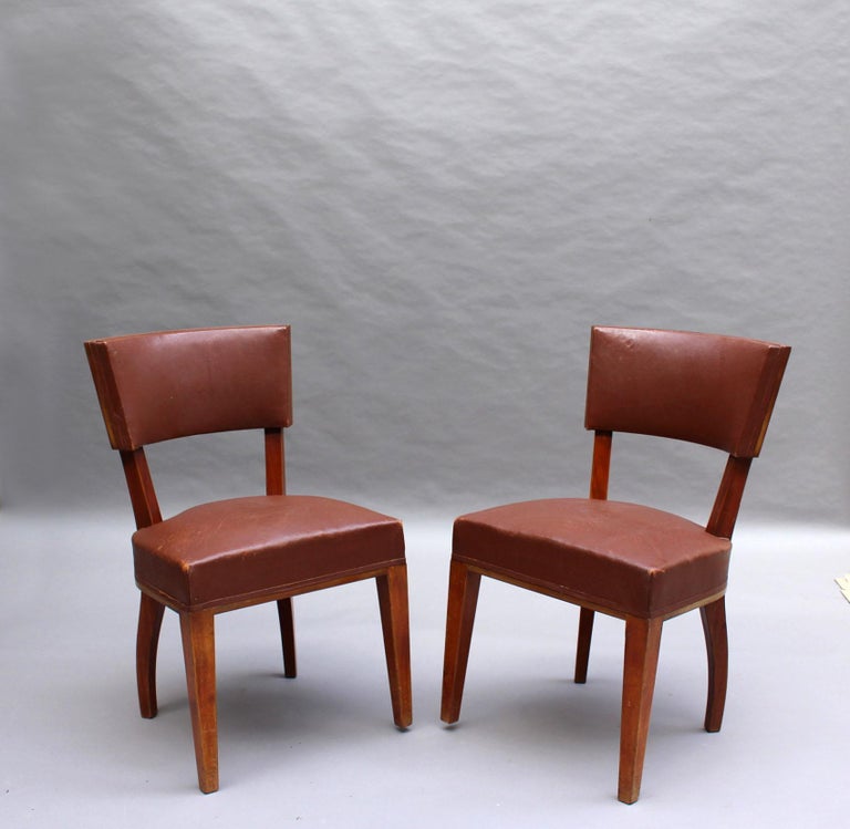 A set of ten 1930s mahogany dining chair with original leather upholstery.
Attributed to Adnet.