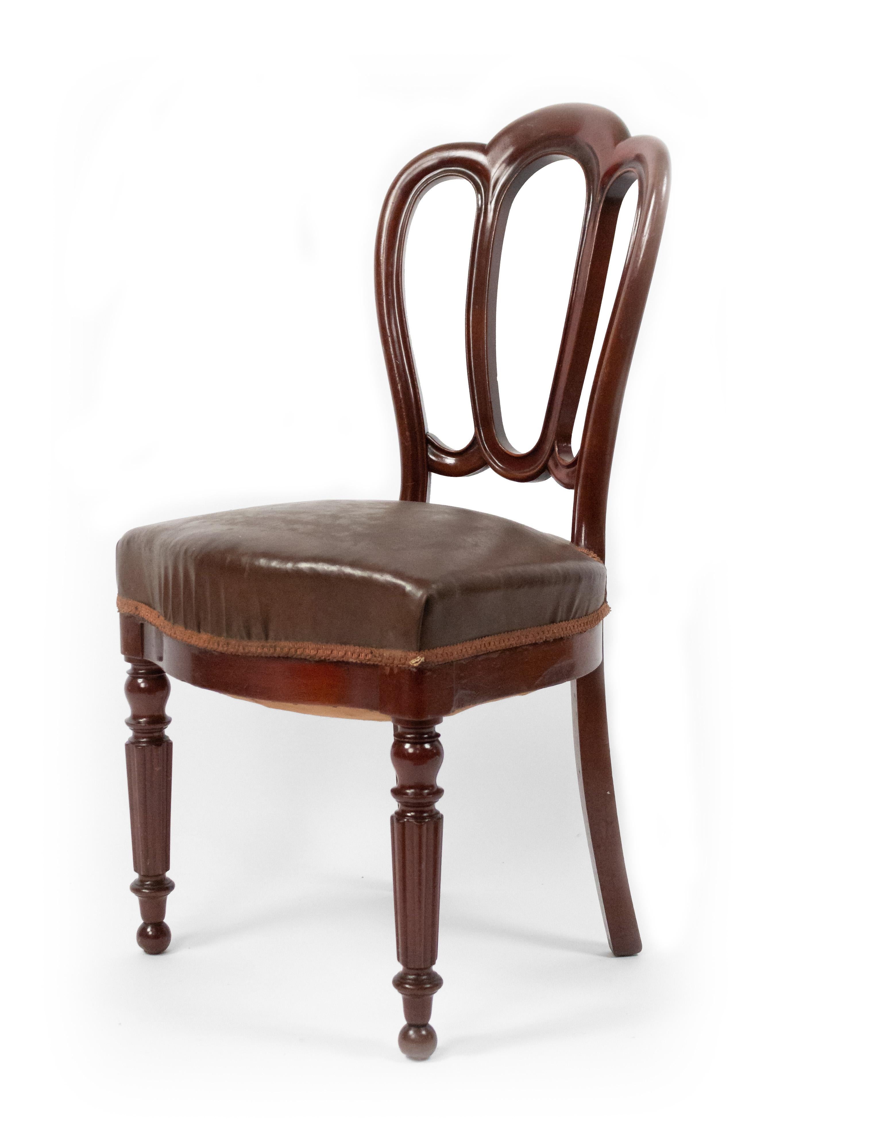 Set of 10 French Victorian (late 19th century) mahogany side / dining chairs with shaped open backs, leather seats, and fluted front legs.