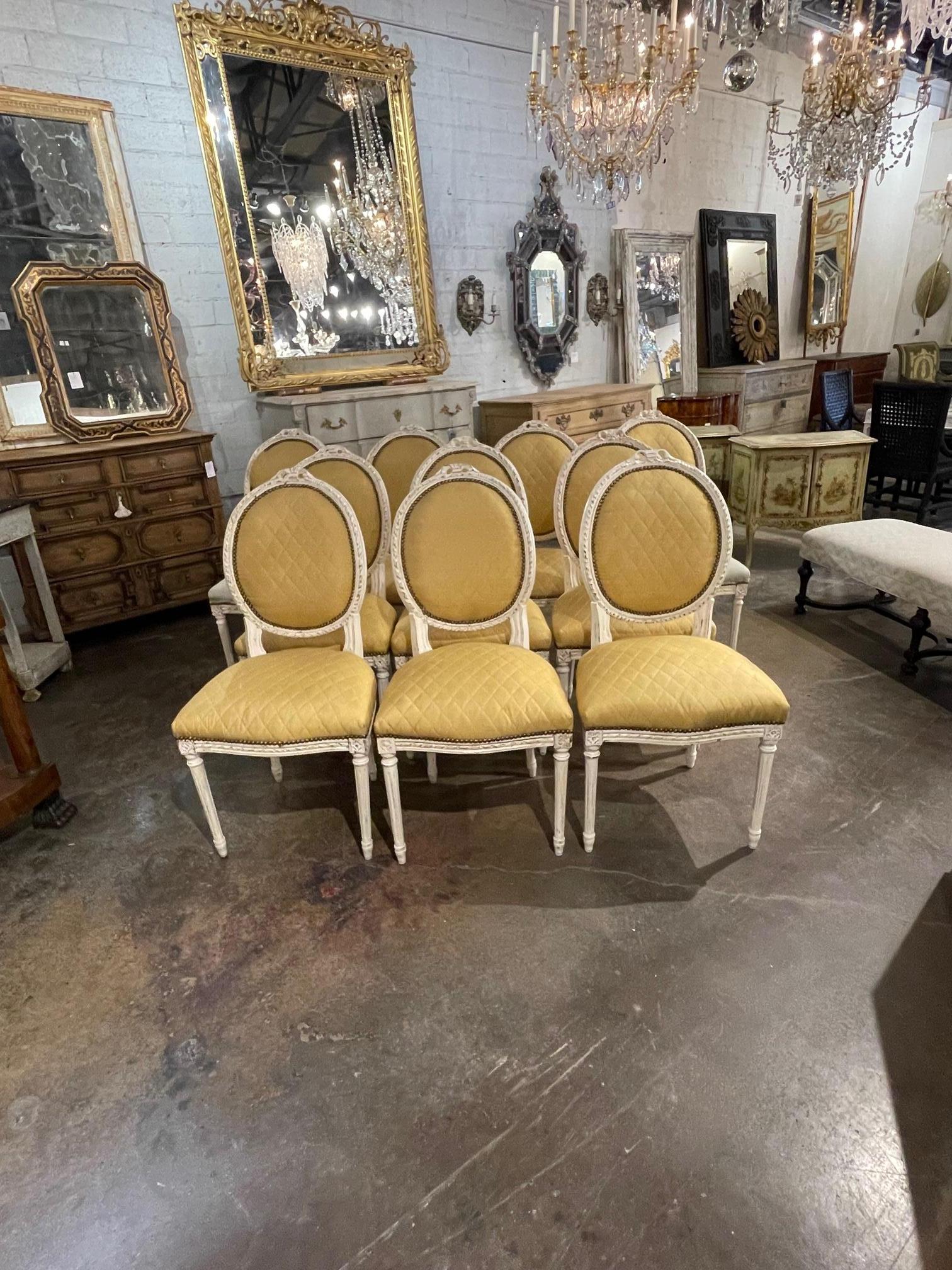 Exceptional set of 10 French Louis XVI carved and painted dining chairs attributed to Jansen. Very nice carvings and pretty white washed finish on the wood. They are upholstered in a gold fabric. A fine set!
Note: Two of the chairs are missing