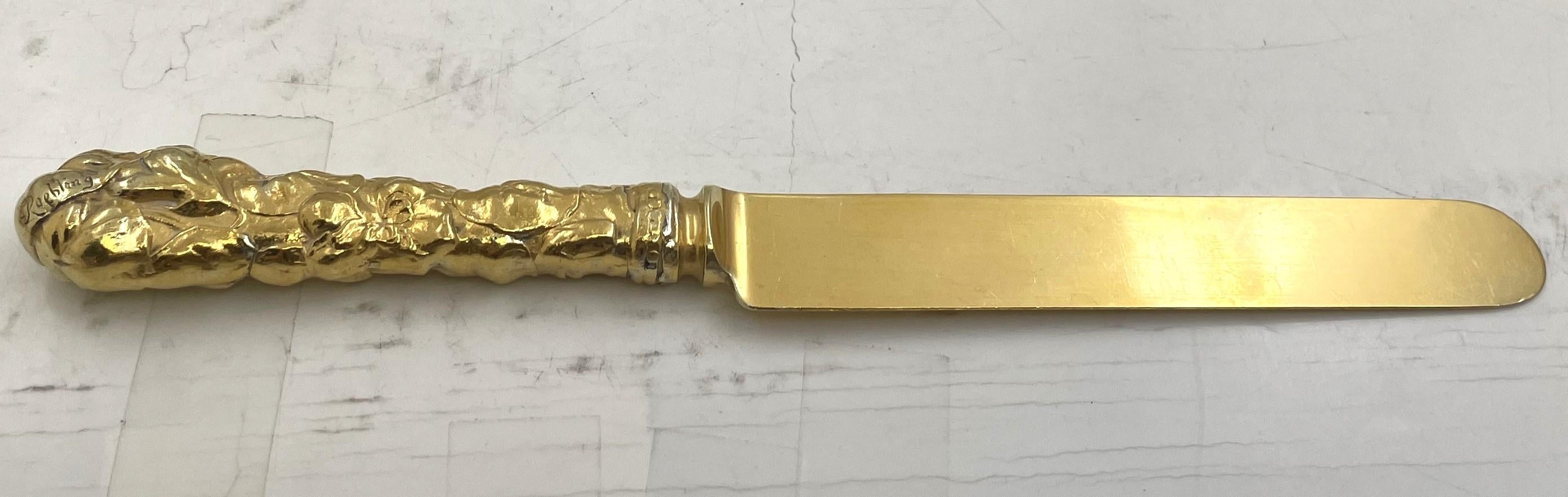 Set of 10 Gorham gilt sterling silver luncheon knives in the Violet pattern, custom made for Washington Augustus Roebling and Emily Warren Roebling, showcasing floral motifs in relief on the handles. They measure 8 1/4'' in length and each has