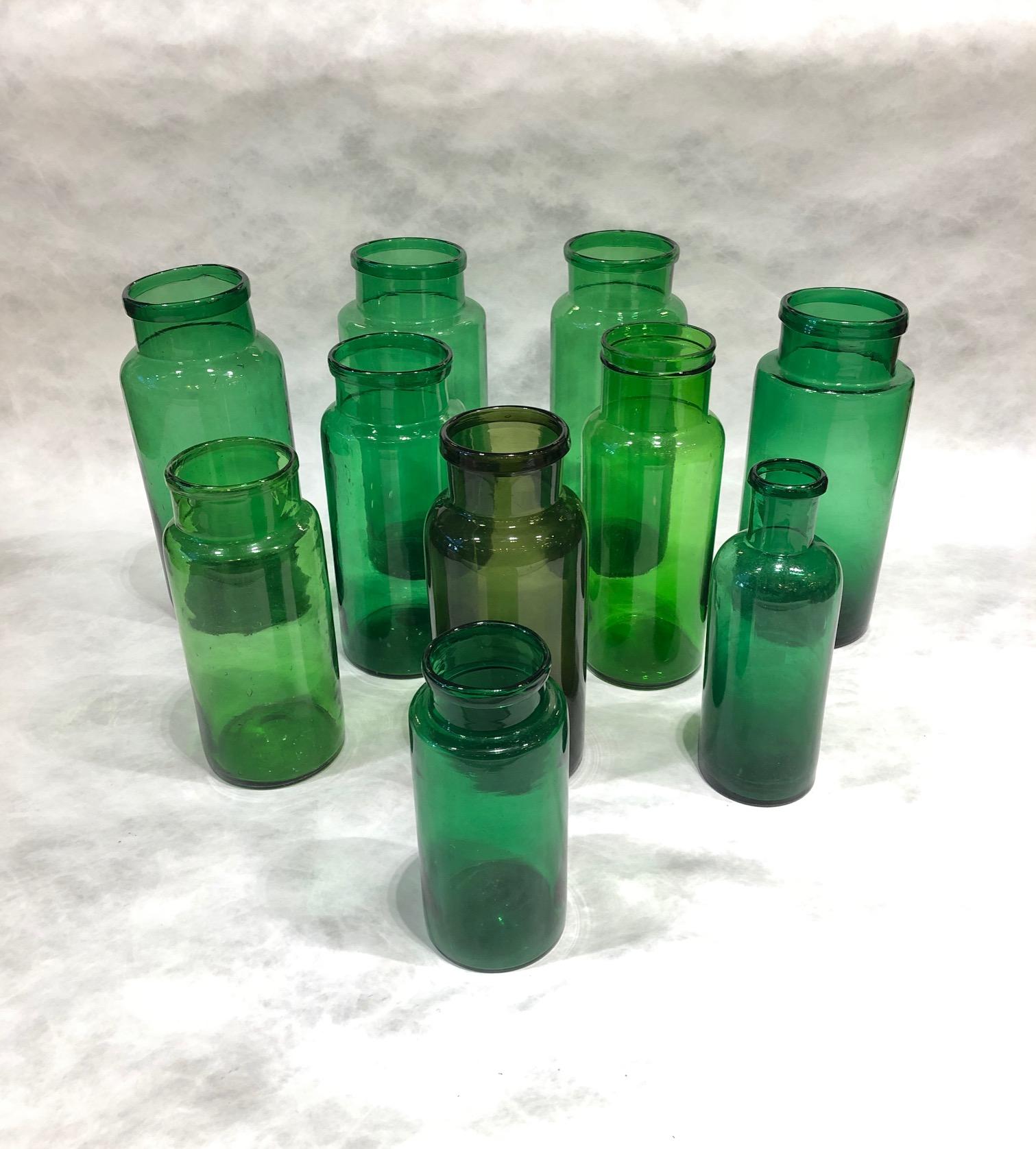 Set of 10 green glass jars in different sizes both diameter and heights, England, circa 1880s. All in the same shade green except one in more of an olive shade.
 
