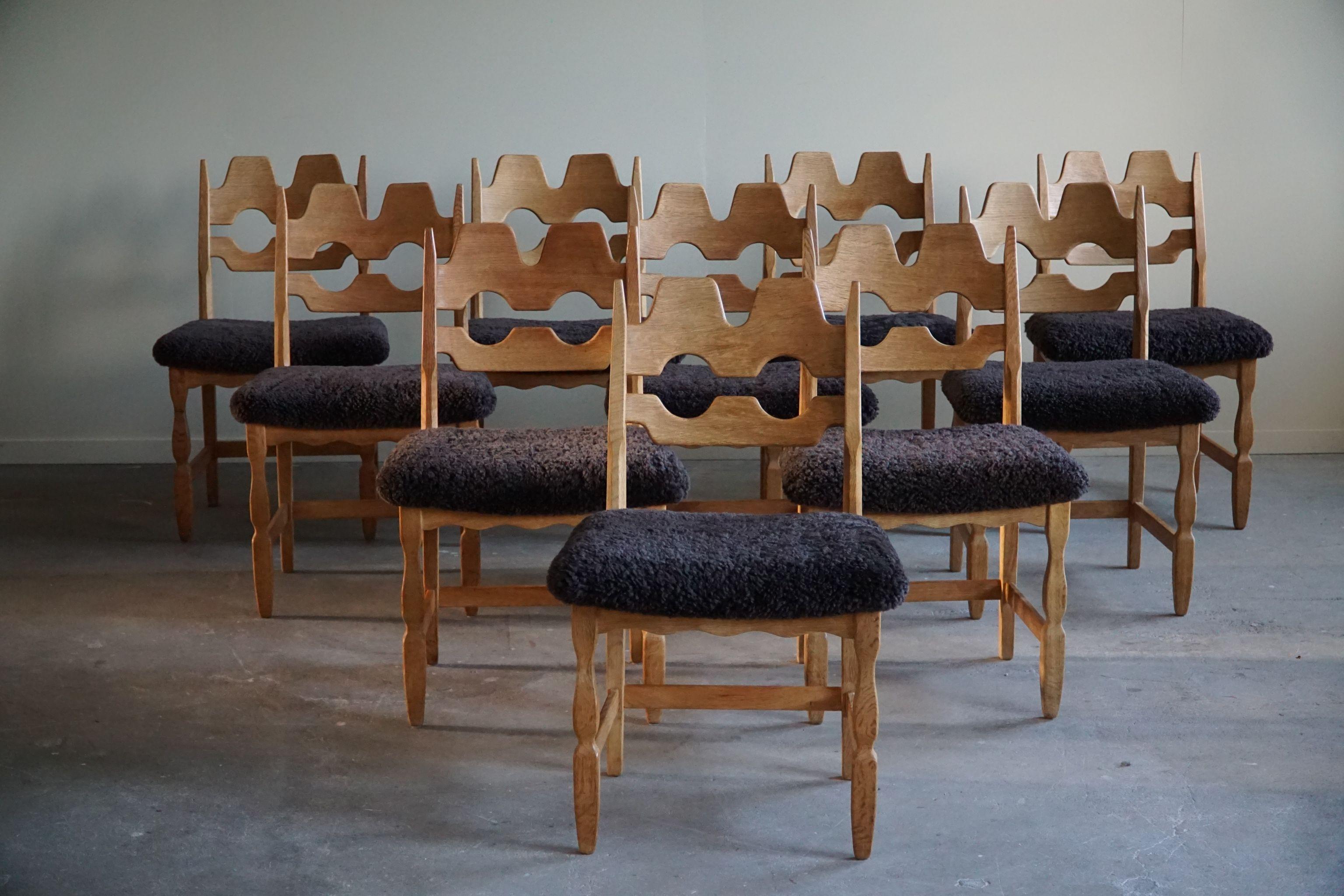 A striking and highly popular sculptural set of 10 classic dining chairs in oak, seats reupholstered in great quality shearling lambswool. Made by Henning (Henry) Kjærnulf for Nyrup Møbelfabrik - ca 1960s. Model 