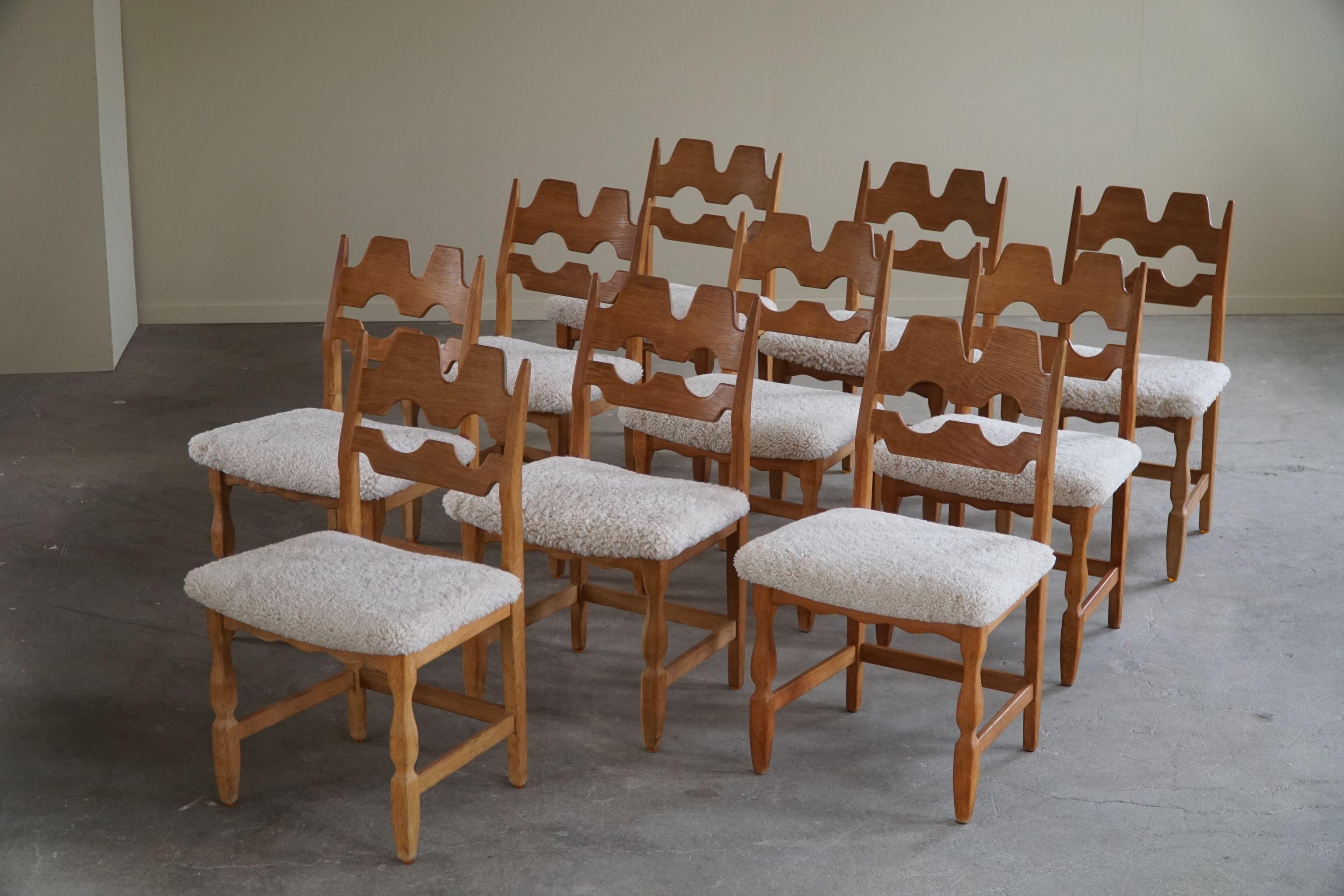 A highly popular and sculptural set of 10 classic dining chairs in oak, seats reupholstered in great quality shearling lambswool. Made by Henning (Henry) Kjærnulf for Nyrup Møbelfabrik - ca 1960s. Model 