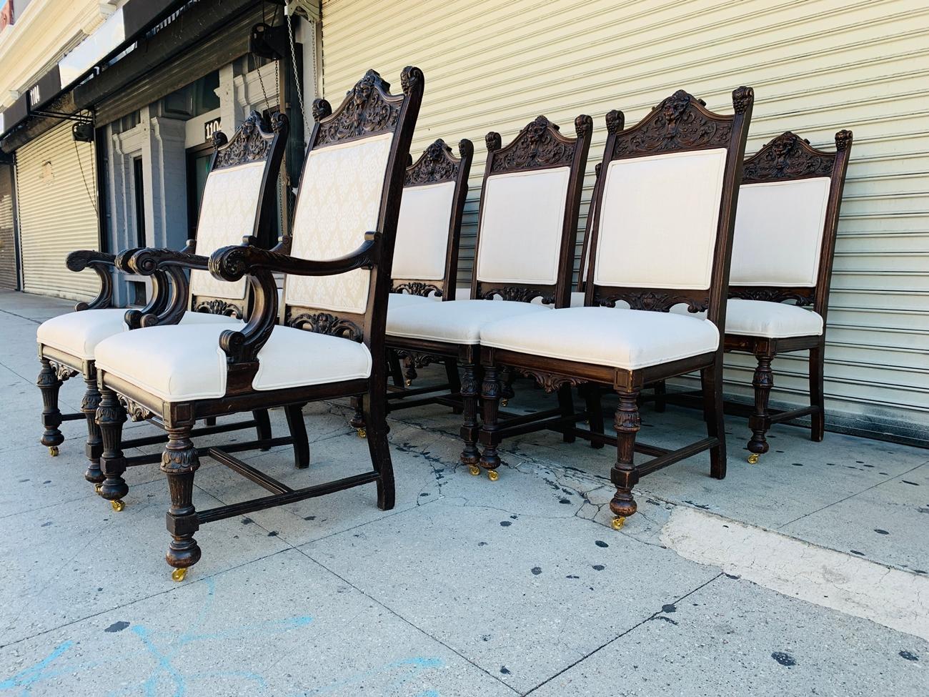 Beautiful set of 10 high back chairs from the early 1900s, the frames are made out of solid wood and heavily carved, the set consist of 8 side chairs and 2 armchairs. The pieces were reupholstered by Castle Interiors Decorating of Brooklyn NY for