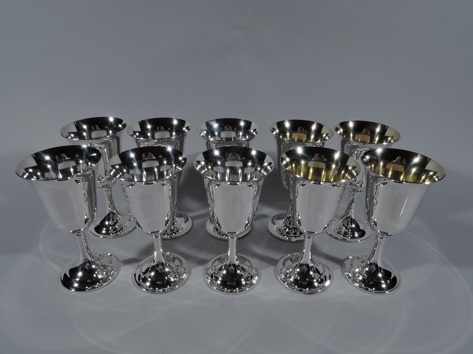 Set of 10 Lord Saybrook sterling silver goblets. Made by International in Meriden, Conn. Each: Tapering bowl with fluted rim, cylindrical stem, and raised foot. Four goblets have gilt-washed interior. A graceful and traditional form that works just