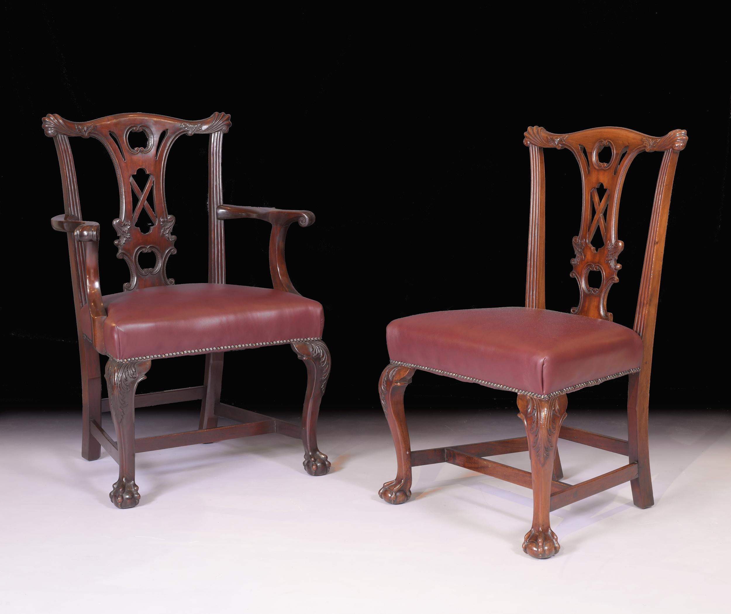 A stunning set of 10 mahogany Chippendale style dining chairs by James Hicks of Dublin. The pierced acanthus carved back splats with “shell” corners upholstered in English burgundy leather, on carved cabriolet legs with cross-stretchers ending on