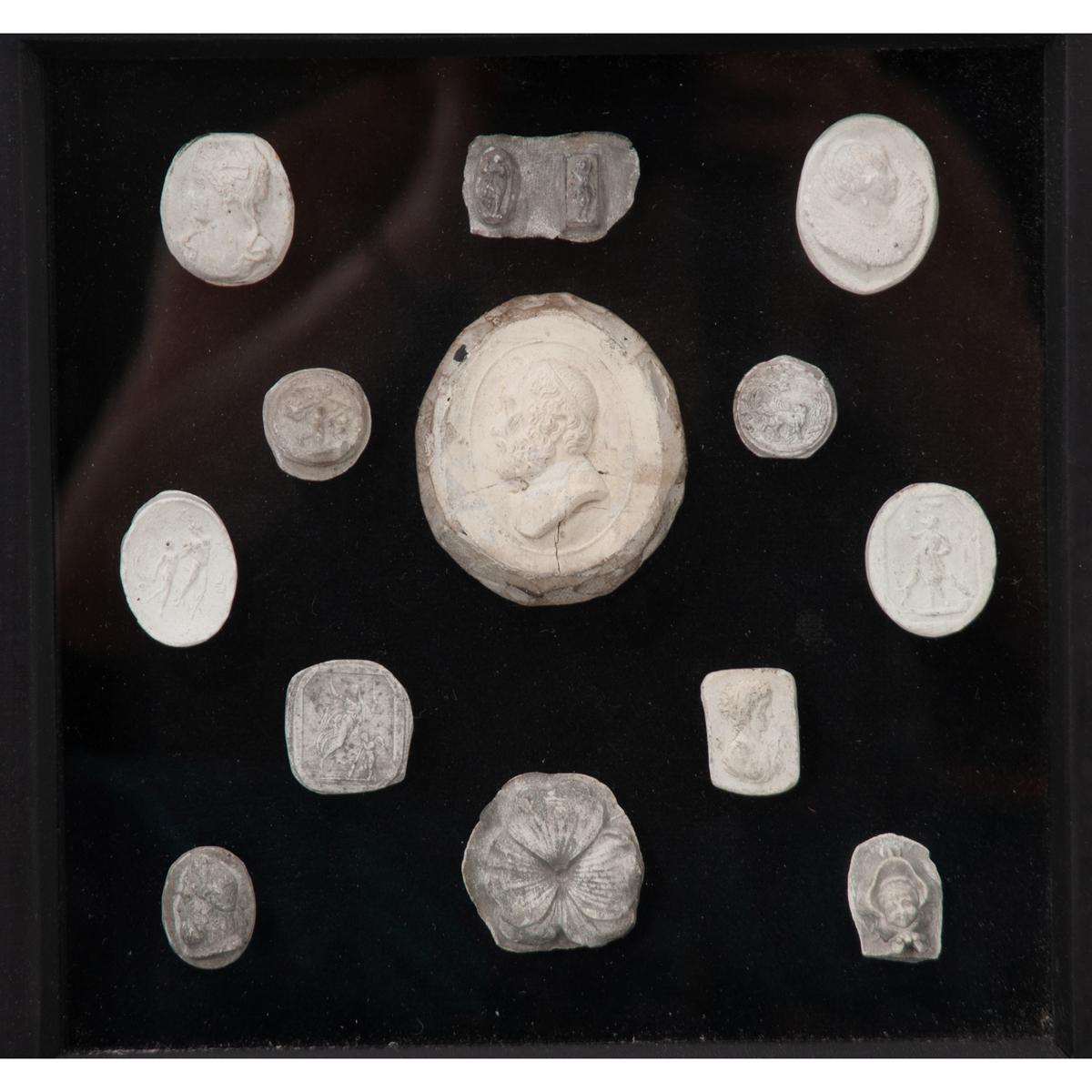 A wonderful collection of cast plaster intaglios. Mounted on black velvet and set in black shadow boxes, the contrast makes the intaglios stand out. All frames are the same size and will make a beautiful display.
