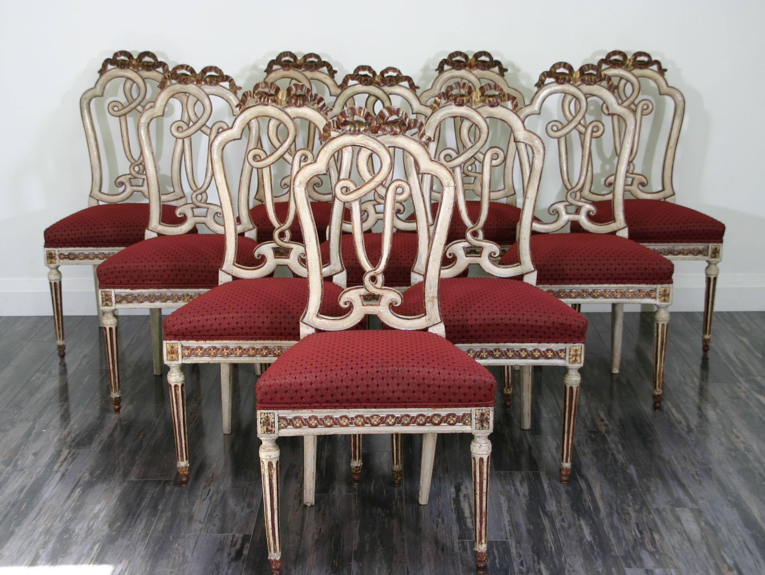 Set of 10 Italian Venetian (18th Century) painted and gilt trimmed side chairs with open carved backs and red upholstered seats supported by fluted legs. (PRICED AS SET)
