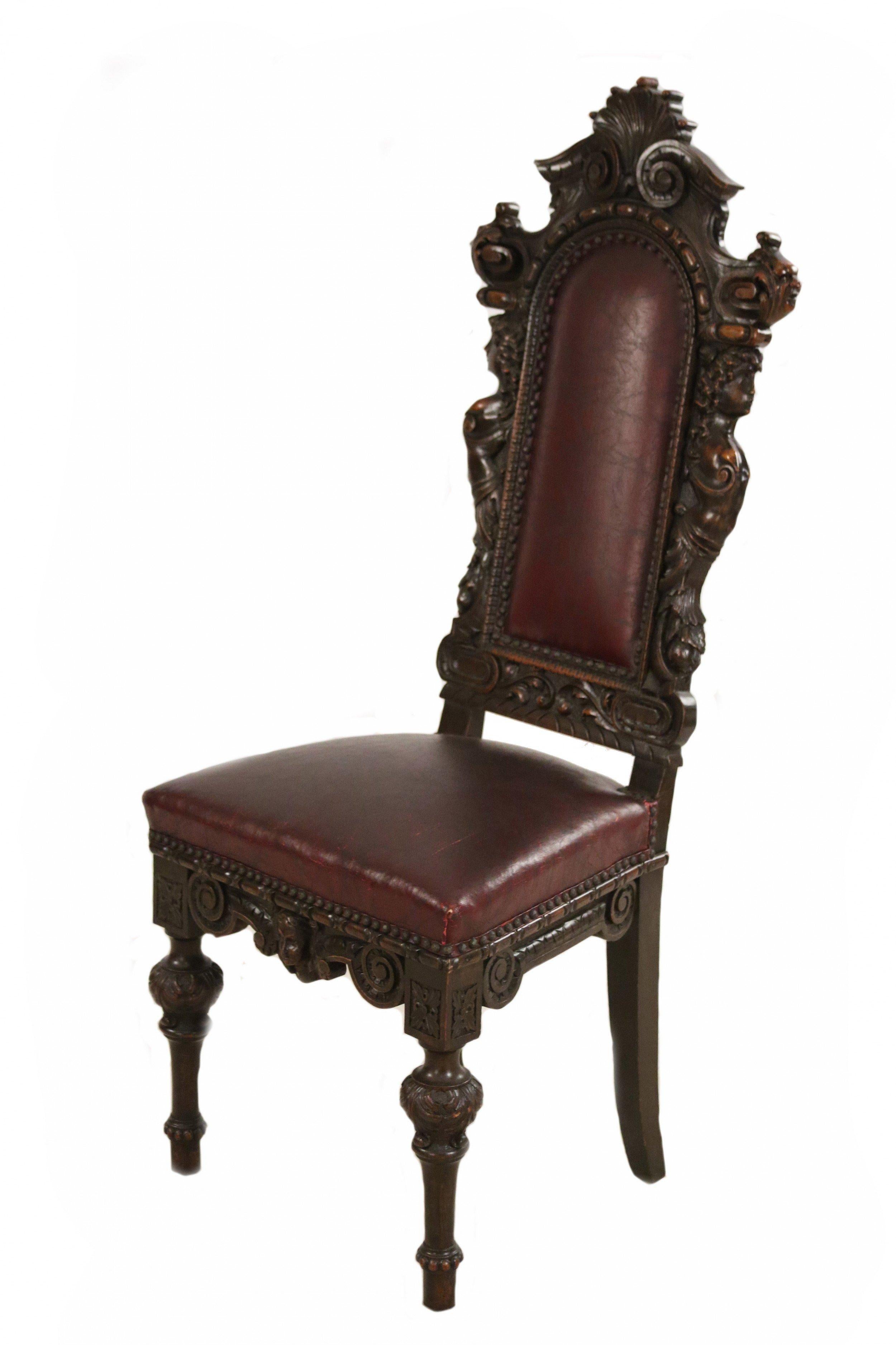Ensemble de 10 chaises latérales à haut dossier en noyer teinté de style Renaissance italienne (19ème siècle) avec têtes sculptées et assise et dossier recouverts de cuir rouge foncé (PRIX POUR L'ENSEMBLE)

État antique