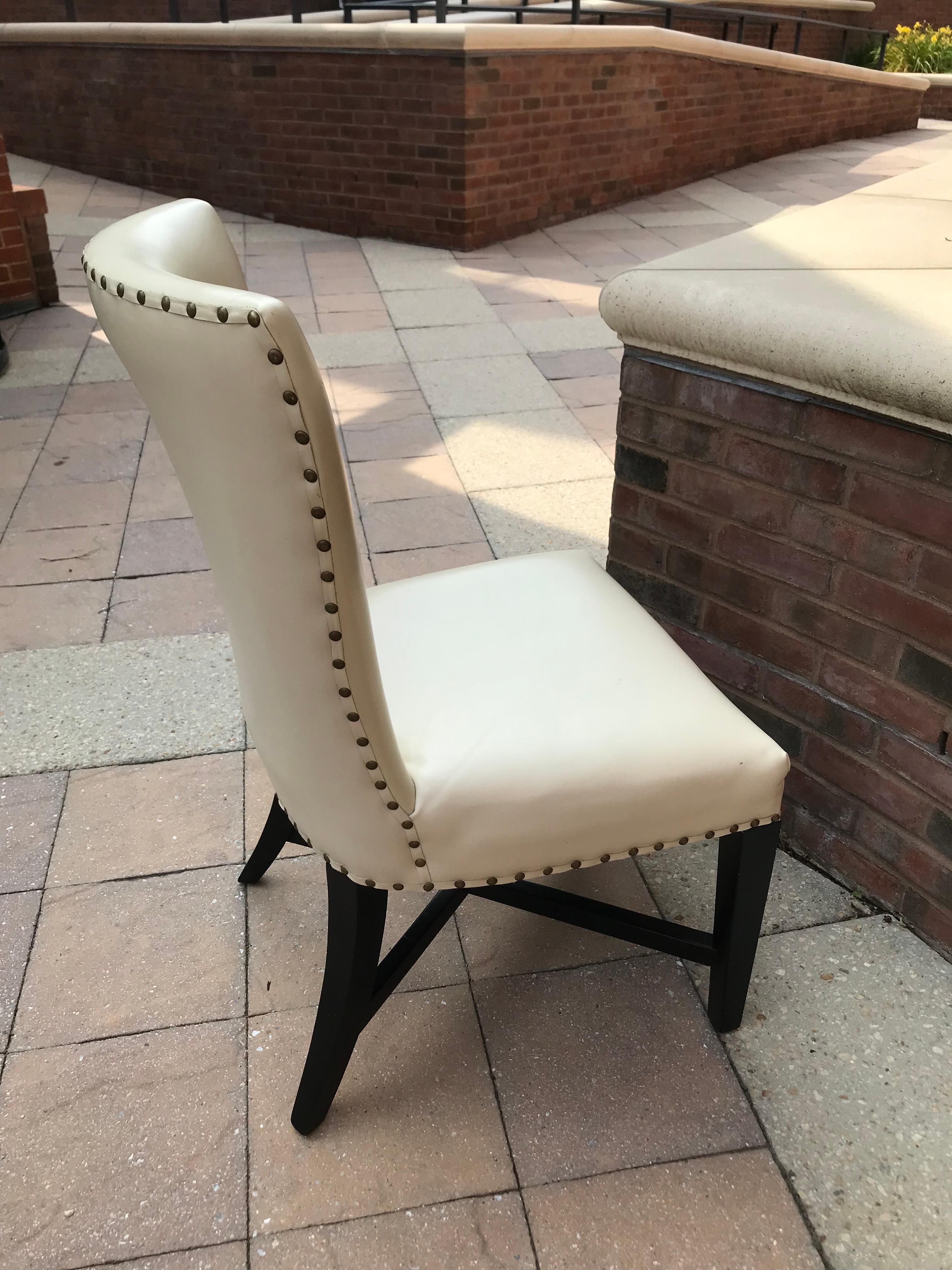 Set of ten elegant and comfortable ivory leather dining chairs finished with antique gold nailhead trim.
Chairs have some leather light surface scuff marks.  Normal wear. 
Seats and backs are padded. 

Seat depth 17.5”
Top of backrest width- 22” 

