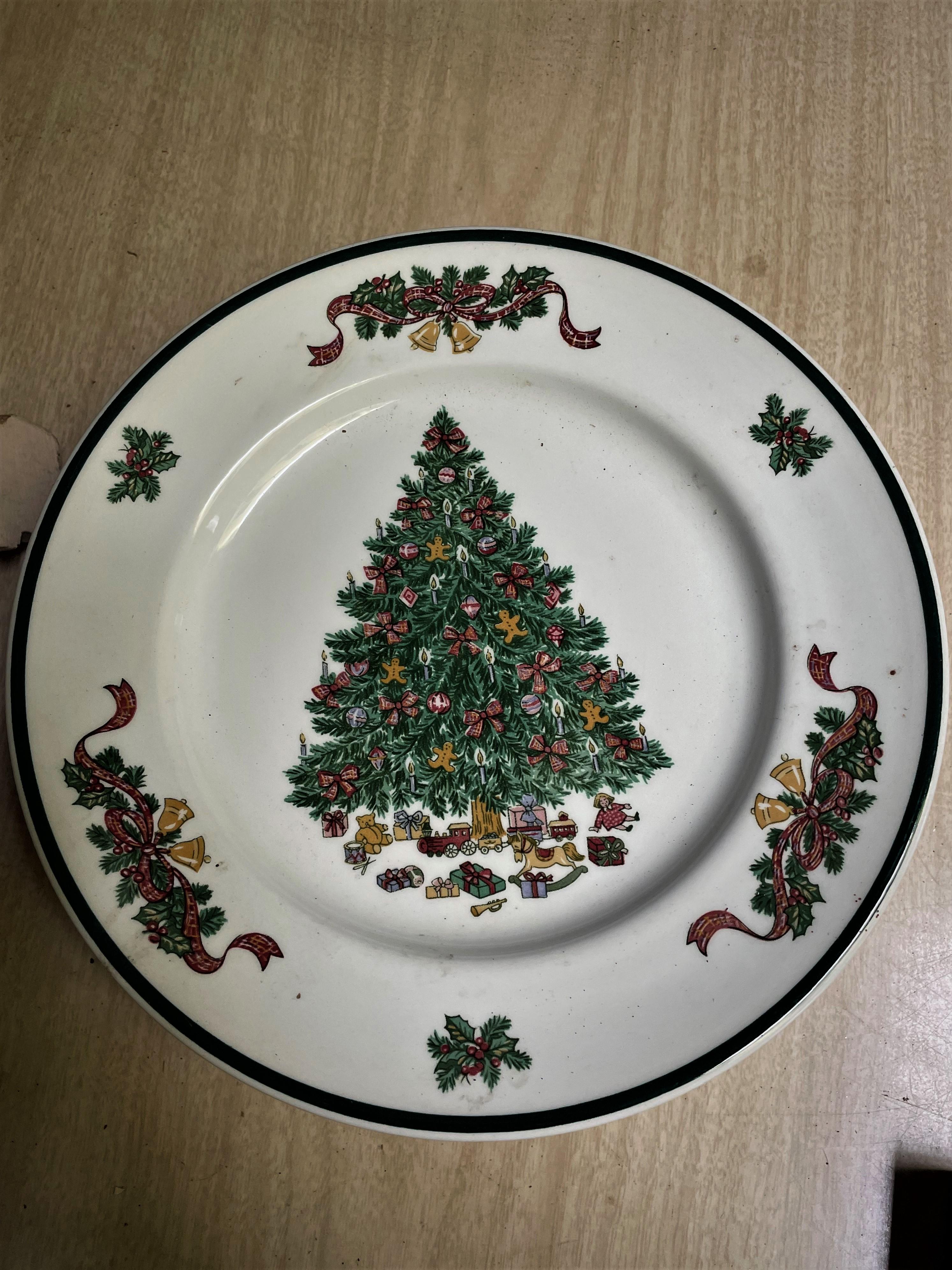 This is a wonderfully decorative set of 10 dinner plates with a grand Christmas tree laden with bows, Gingerbread men, candles and round ornaments and displaying lots of toys and wrapped packages underneath it. There are bells, holly and bows spaced