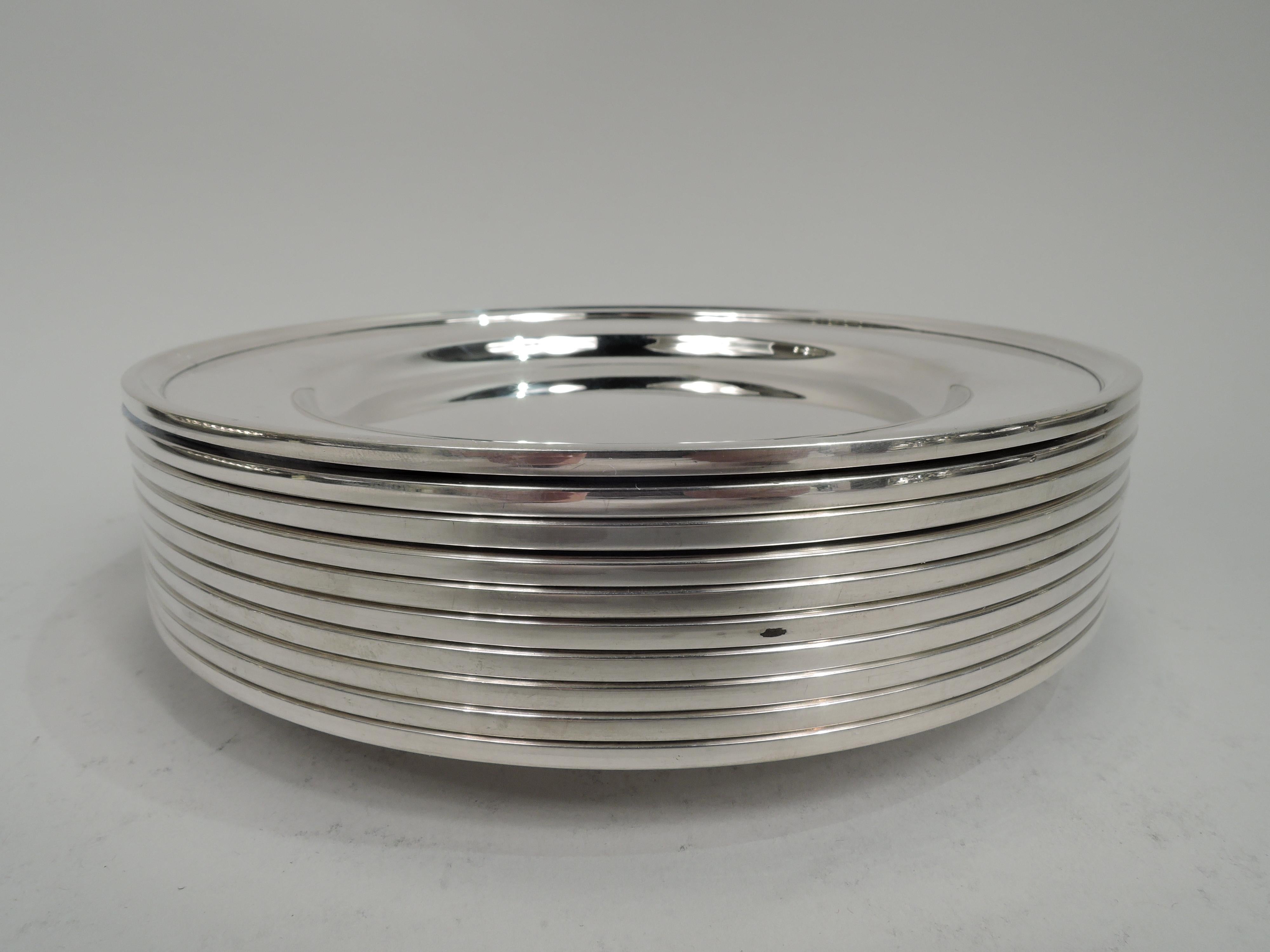 Set of 10 Modern sterling silver bread & butter plates. Made by S. Kirk & Son Inc. in Baltimore. Round well, wide shoulder, and molded rim. Fully marked including maker’s stamp (1925-32) and no. 4100. Total weight: 44.5 troy ounces.