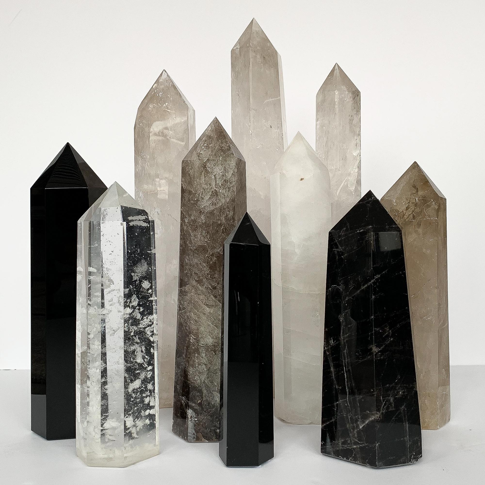 Set of ten large quartz and obsidian crystal obelisks. The obelisks range in height from 12.5