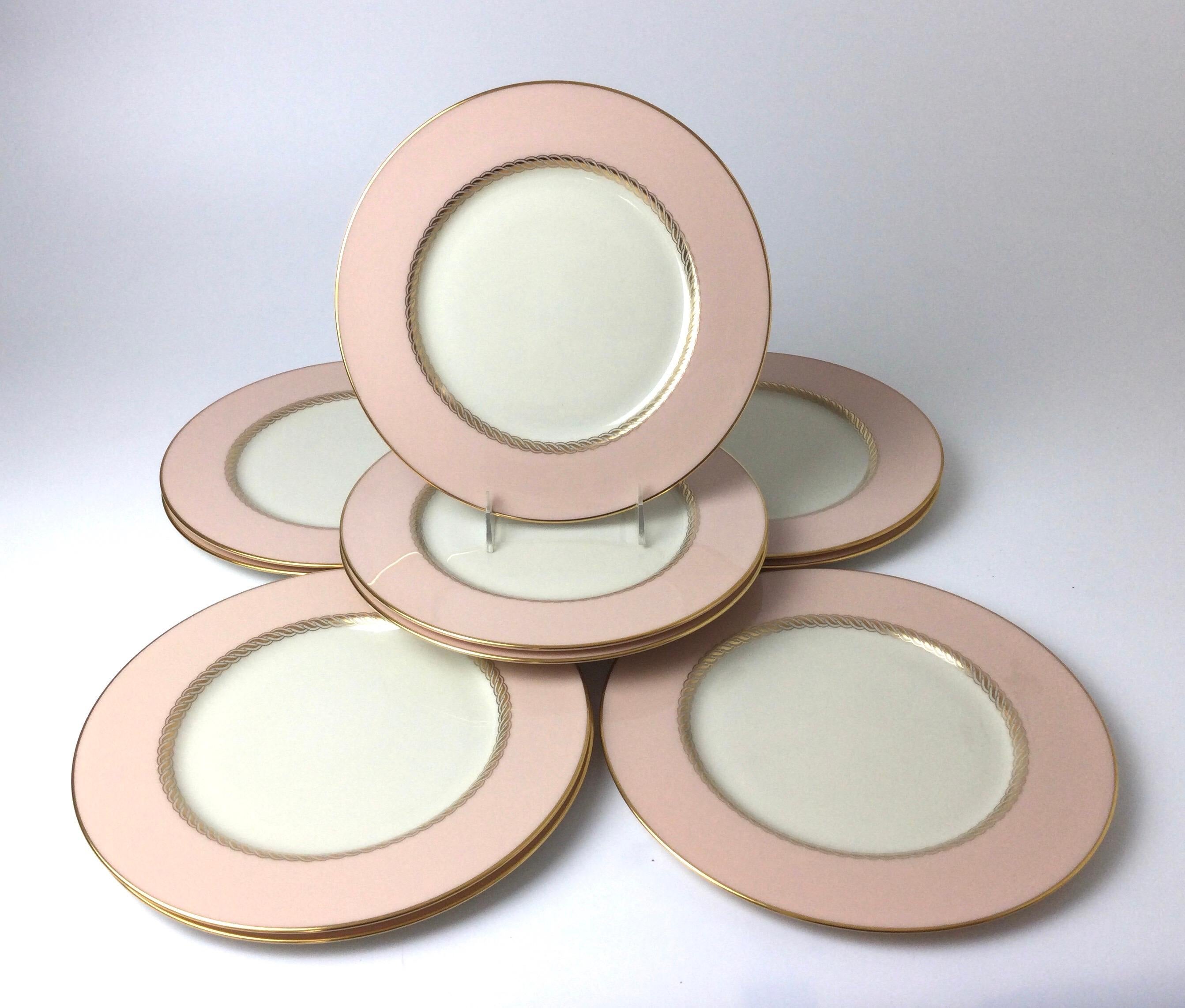 Set of 10 Lenox Caribbee service dinner plates with pink and gilt borders. Measure: 10 1/2