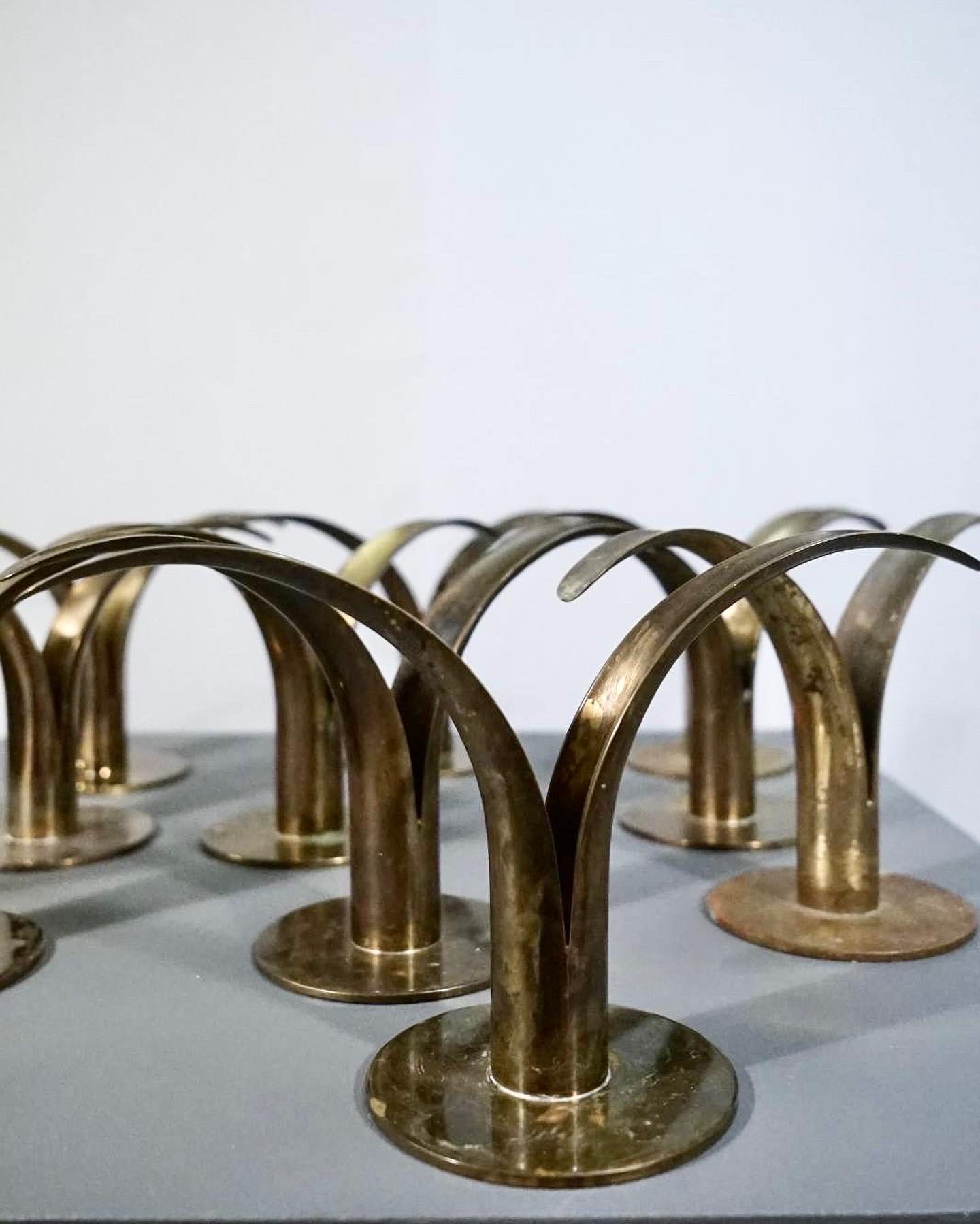 Rare set of 10 lily candle holders in patinaed brass designed by Ivar Ålenius Björk for Ystad Metal.
The candle holders are in good original condition with a beautiful patina.
Set of 10 available but we got more in stock if wanted.