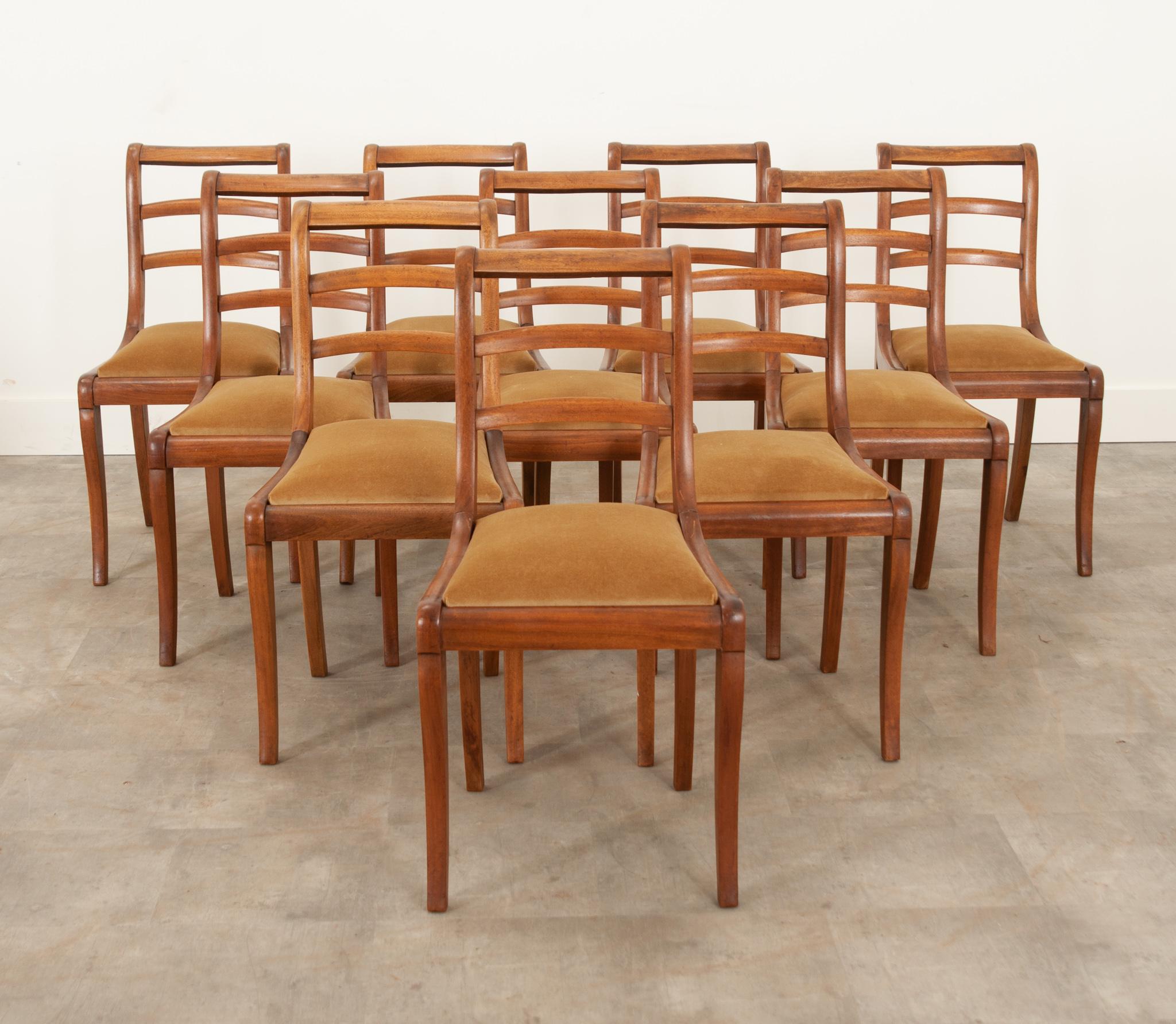 We love this set of 10 mahogany dining chairs from France. Recently reupholstered in a velvet from Schumacher, the warm fabric complements the rich coloring of solid wood frames, and is designed to be stain and scratch resistant. The back support is
