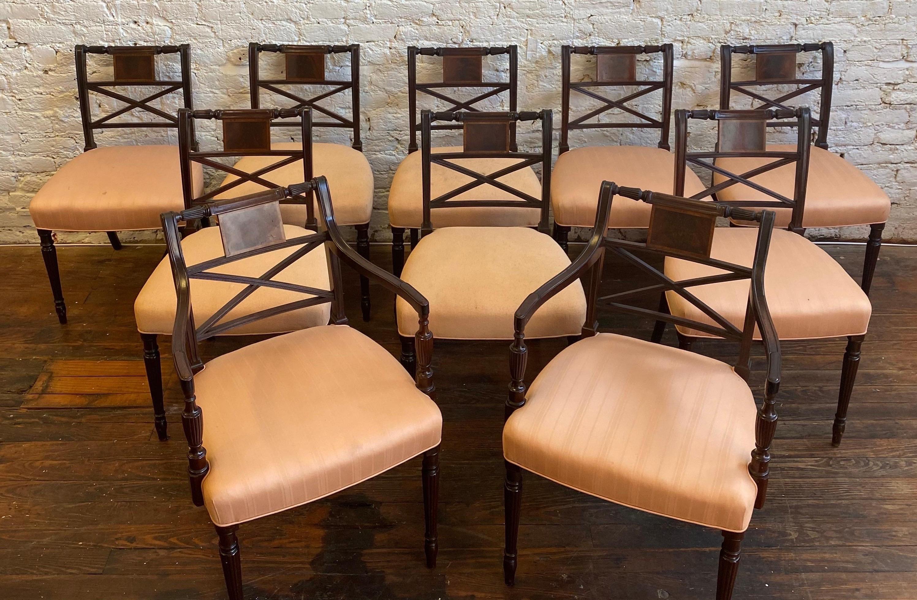 Great set of early 20th century mahogany dining chairs. 8 sides and 2 arms. Six of the chairs are upholstered in a striped pattern fabric and the other 4 are in a solid fabric- all 10 are of the same color.

8 side chairs measure: 21