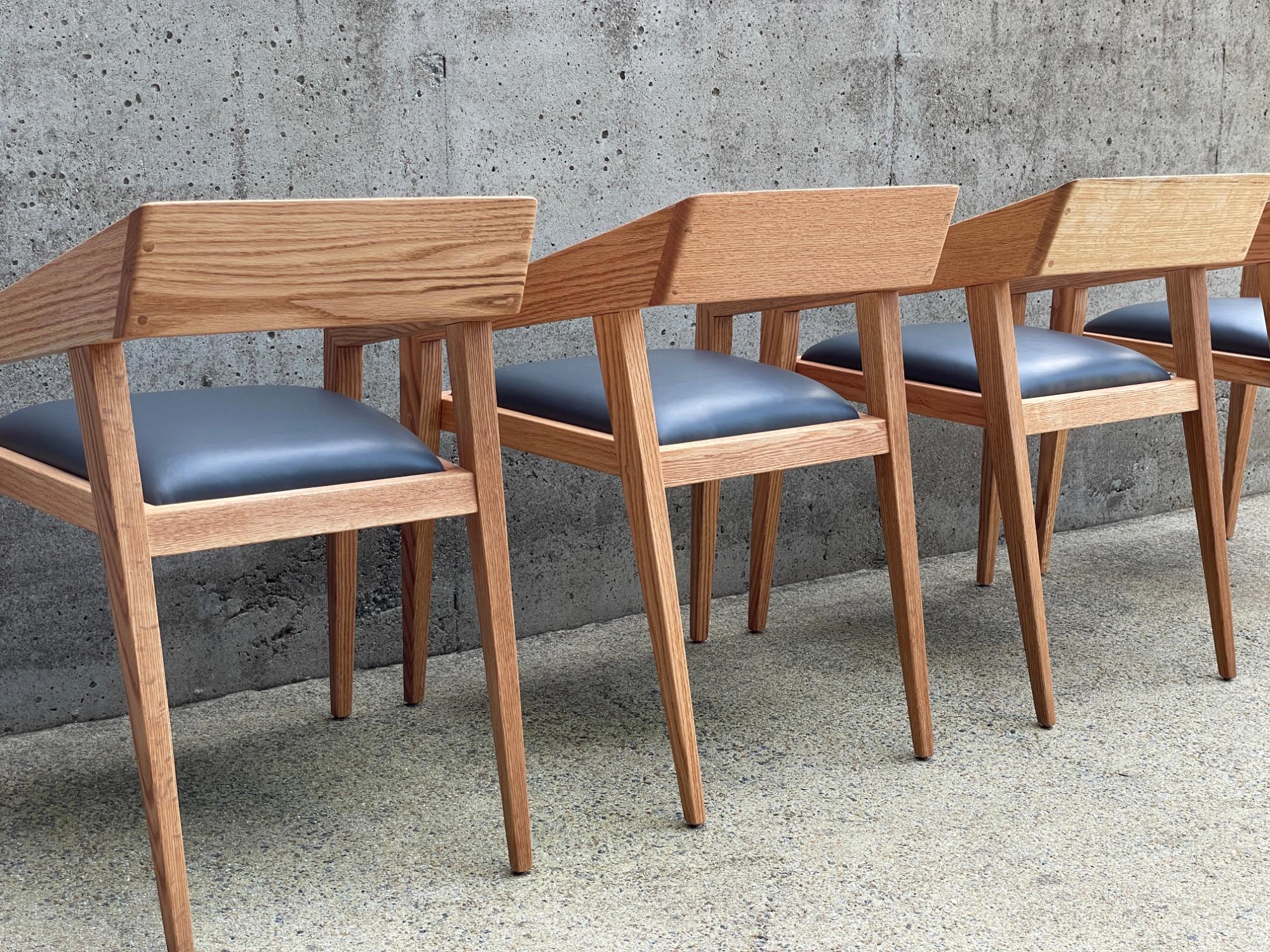 Leather Set of 10 Marco Bogazzi dining chairs with arms and leather seats For Sale
