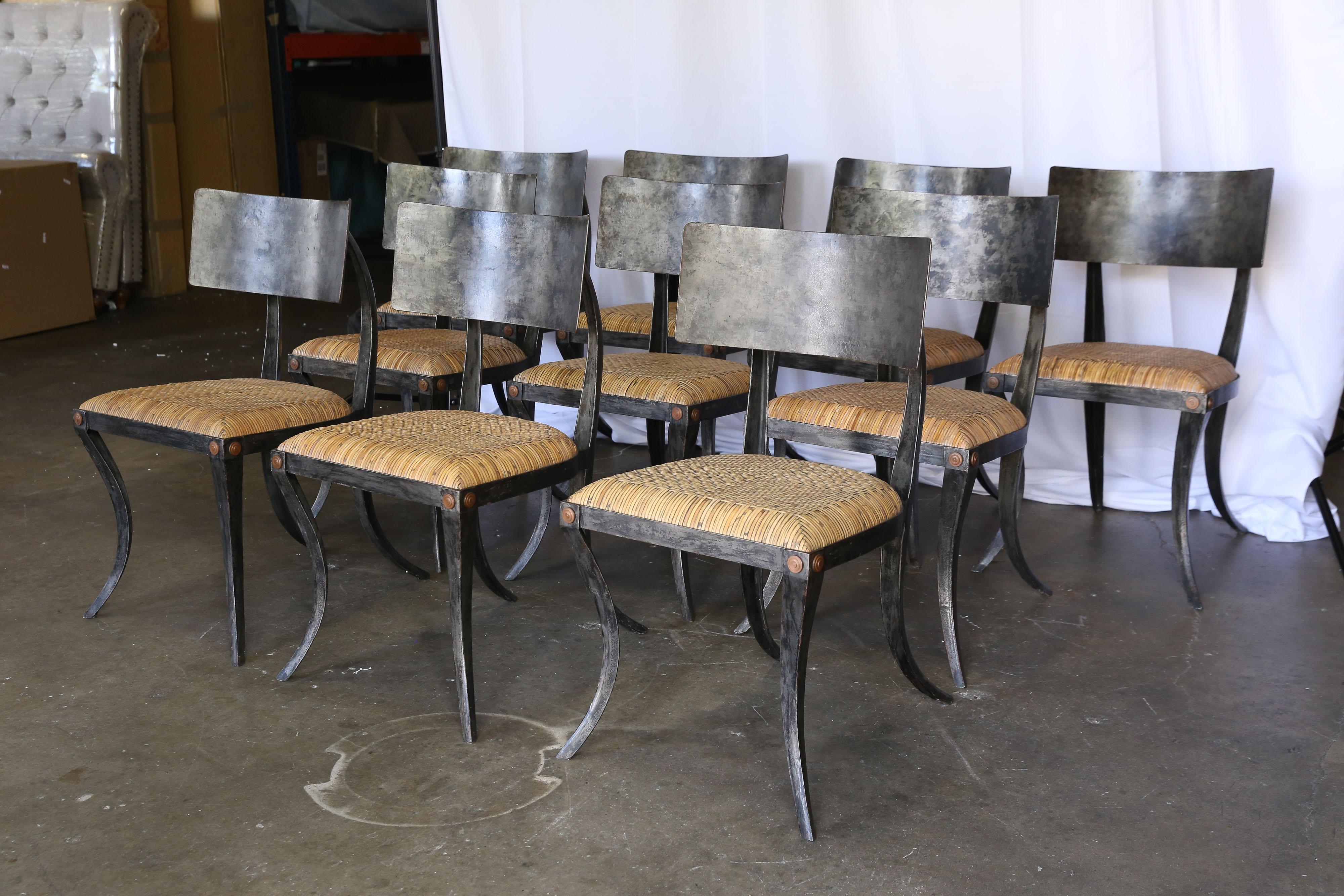 Set of 10 metal Klismos chairs by Ched Berenguer-Topacio with woven rattan seats. Patinated wrought iron with brass details at front legs. Excellent condition and very comfortable. Measures: Seat depth 16.5