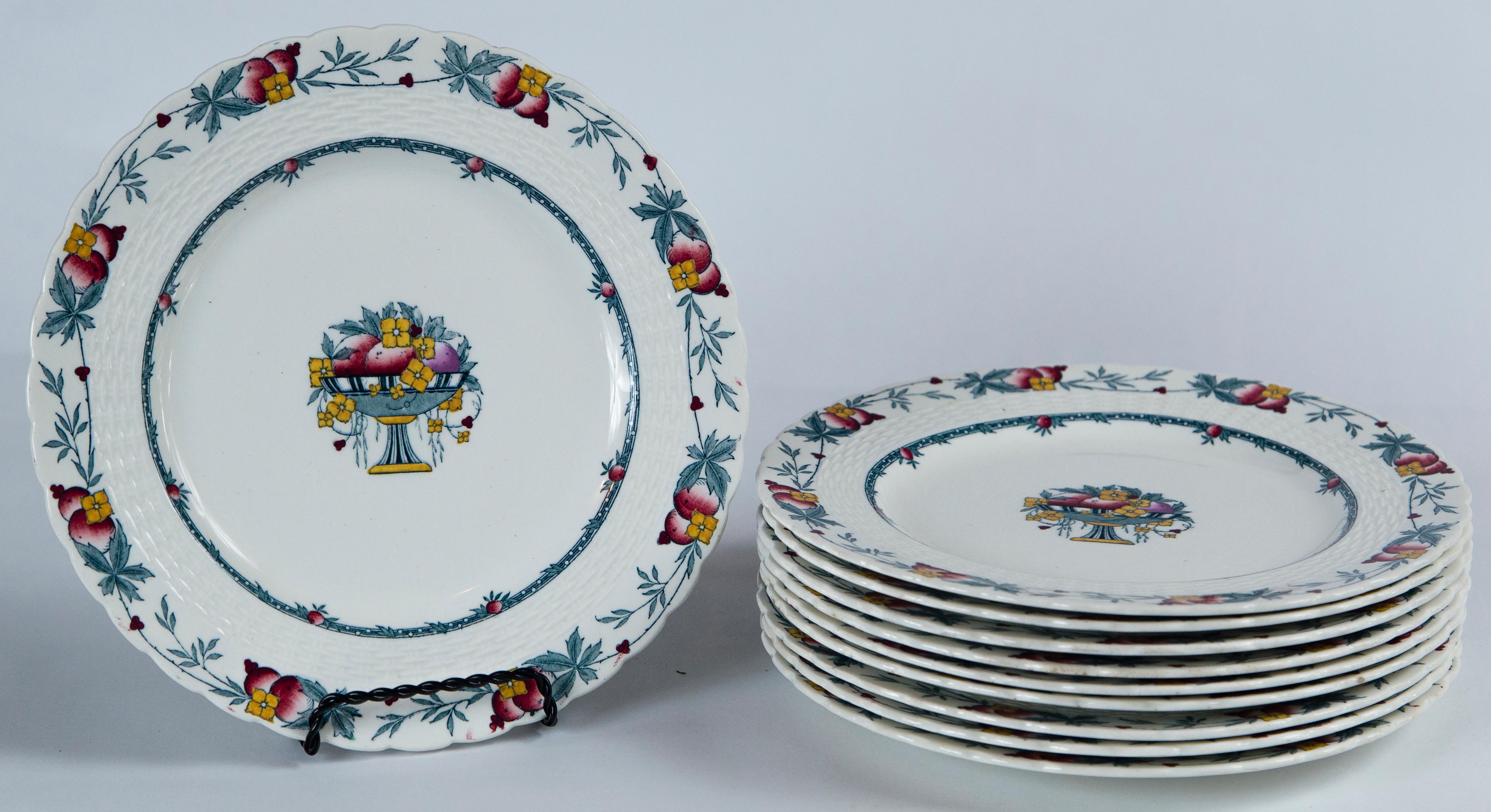 Set of 10 Minton's Stanhope plates, England, circa 1900. The Stanhope pattern features a fruit and floral border and center design with a blue and gold palette. There is a raised basket weave detail and scalloped rim. Minton's mark.

  