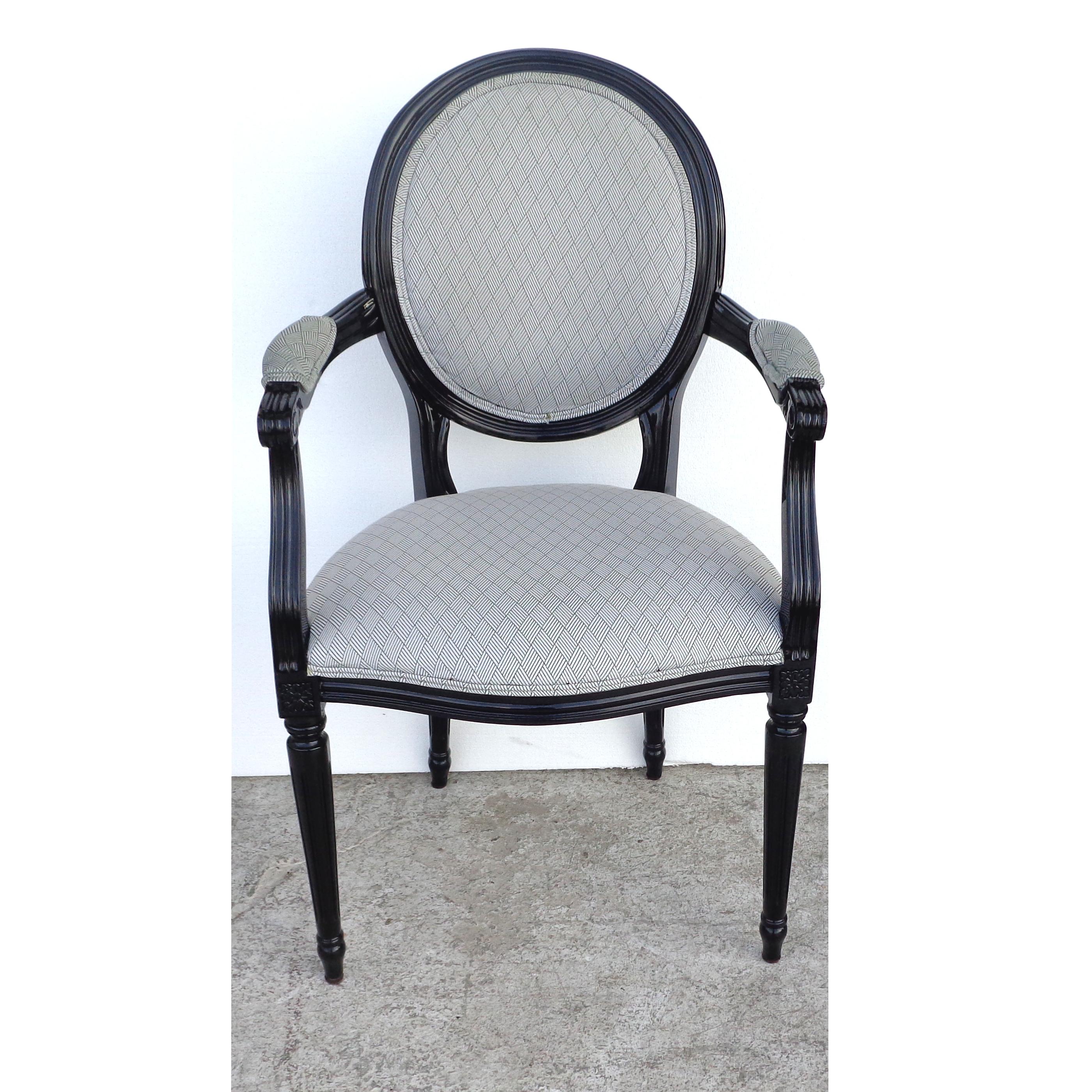 Neoclassical Louis XVI style dining chairs

Set of 10 Directoire-style dining chairs. Ebonized frames with rounded oval backs. Both sides and seats are upholstered in a rich grey diamond patterned fabric. French style base with column-like legs