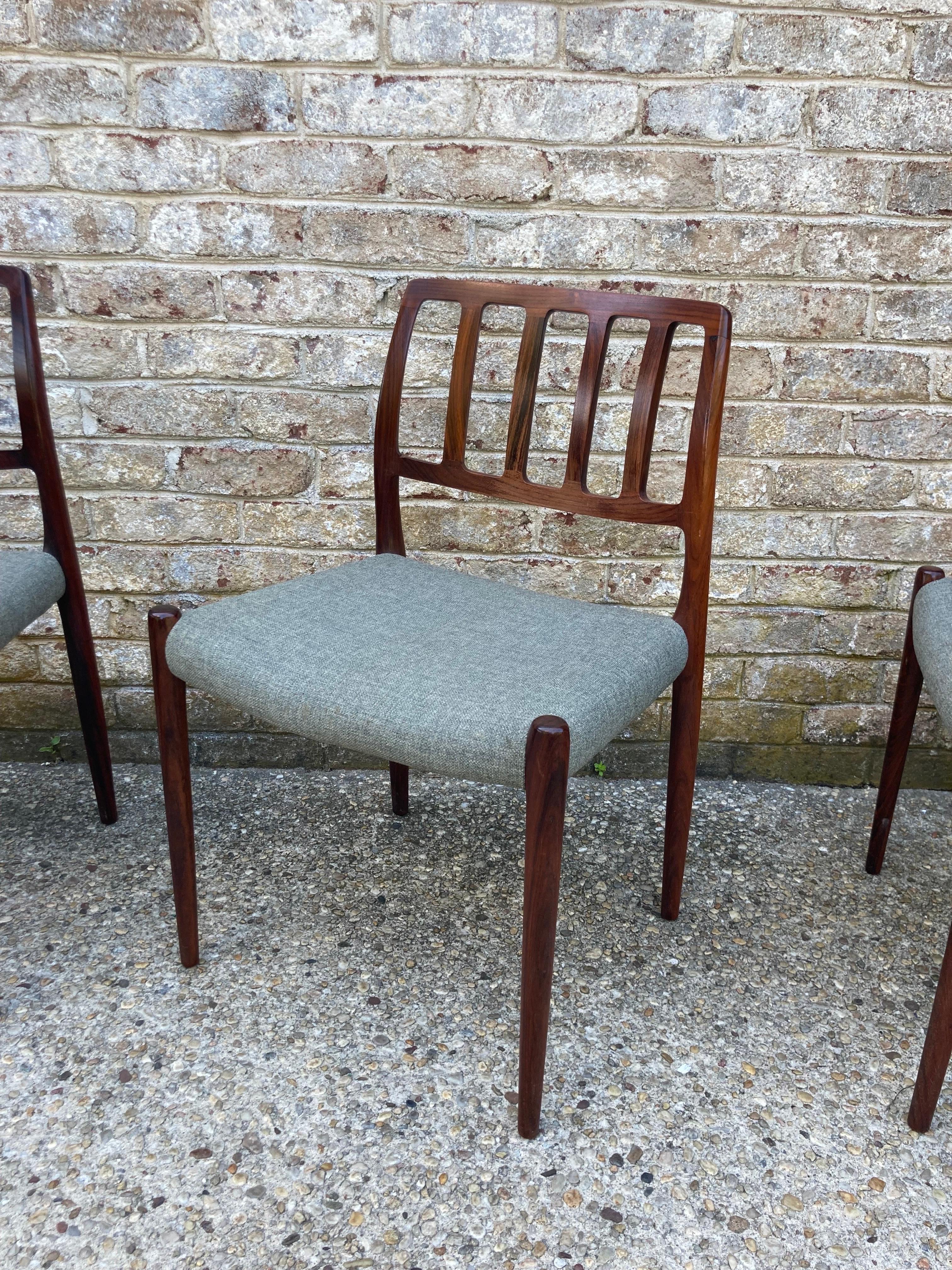 A large set of 10 Niels Moller dining chairs in rosewood with original wool seats.... nos 66 and 83, with 2 arm chairs and 8 side chairs.