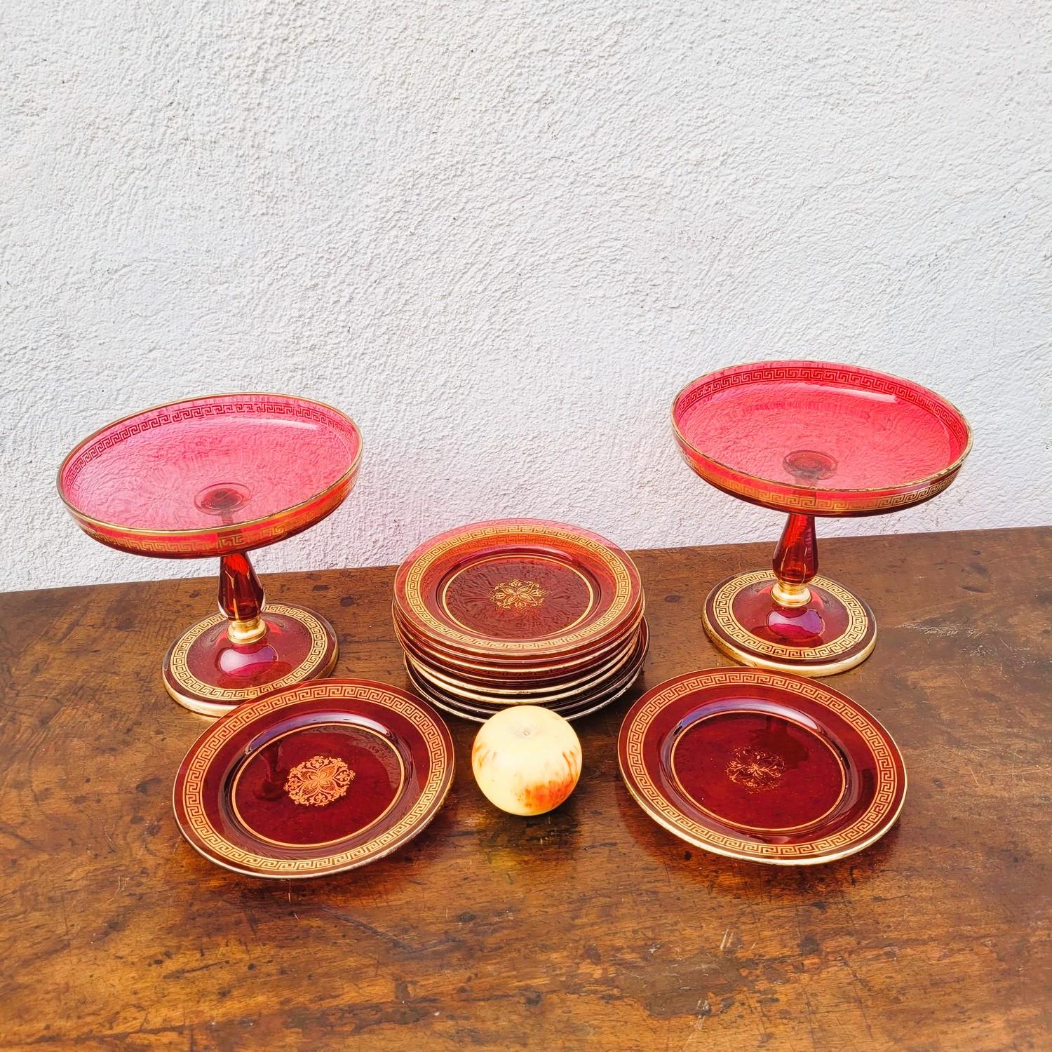 Set of 10 plates and 2 fruit bowls in Ruby-colored glass, and a gold-painted decoration

Plates in perfect condition, a tiny chip on one of the bowls; wear to the gilding

late 19th century, early 20th century

Dimensions of the plates: diameter