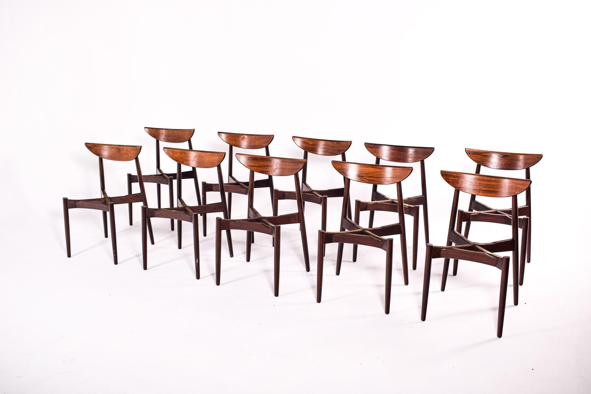 Stunning, solid rosewood set of ten dining chairs by one of the Danish great designers. Harry Ostergaard designed these dining chairs in the 1950s. The chairs feature elegant rosewood frames with curved backrests and tapered legs. Reupholstering.