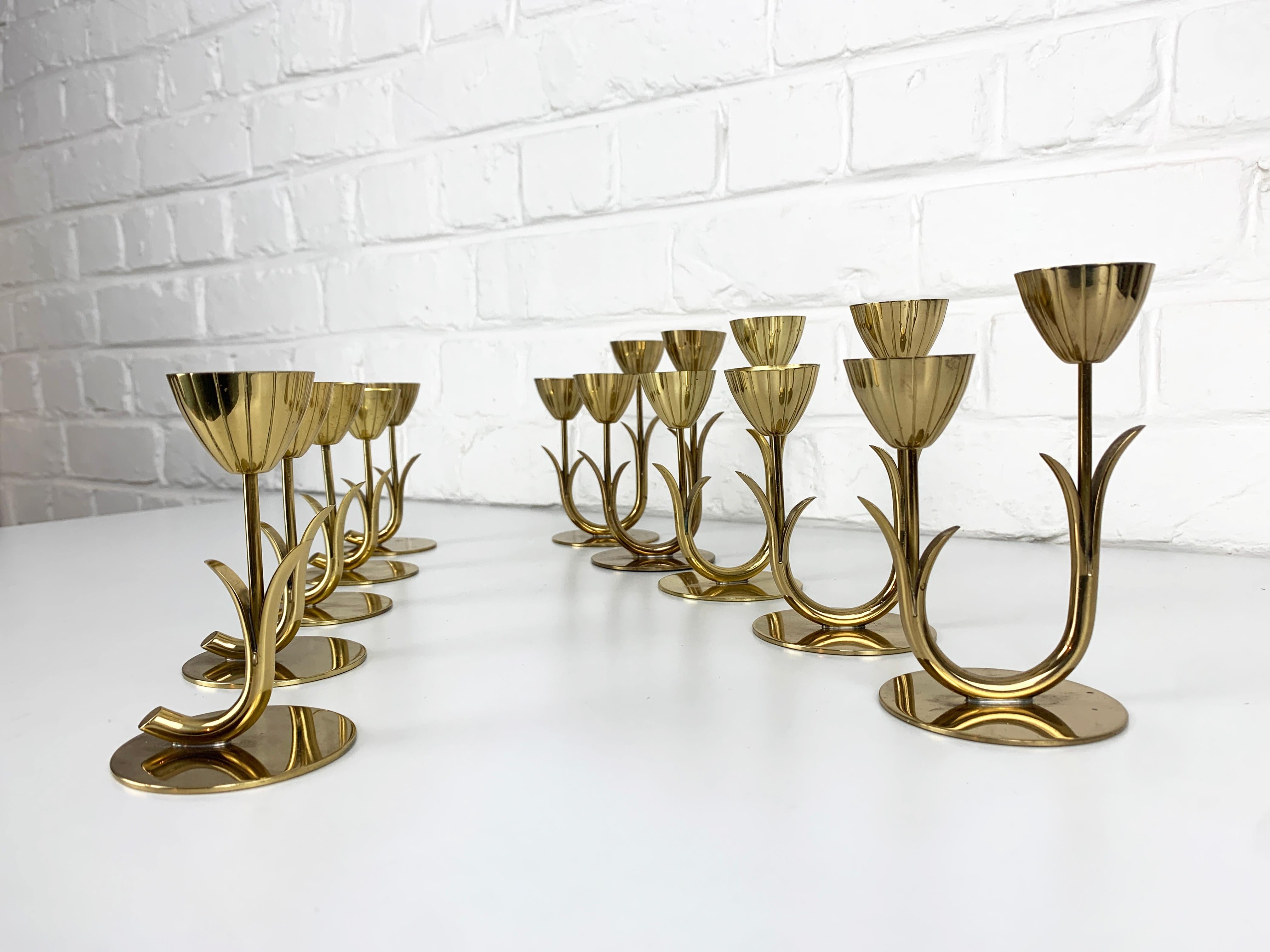 Set of 10 modernist candlesticks designed by Gunnar Ander. Their formal language remind the Swedish Grace style. Produced by Ystad-Metall, located in the town of Ystad in Sweden. 

Candle-holders in solid brass. Organic design of stylised flowers