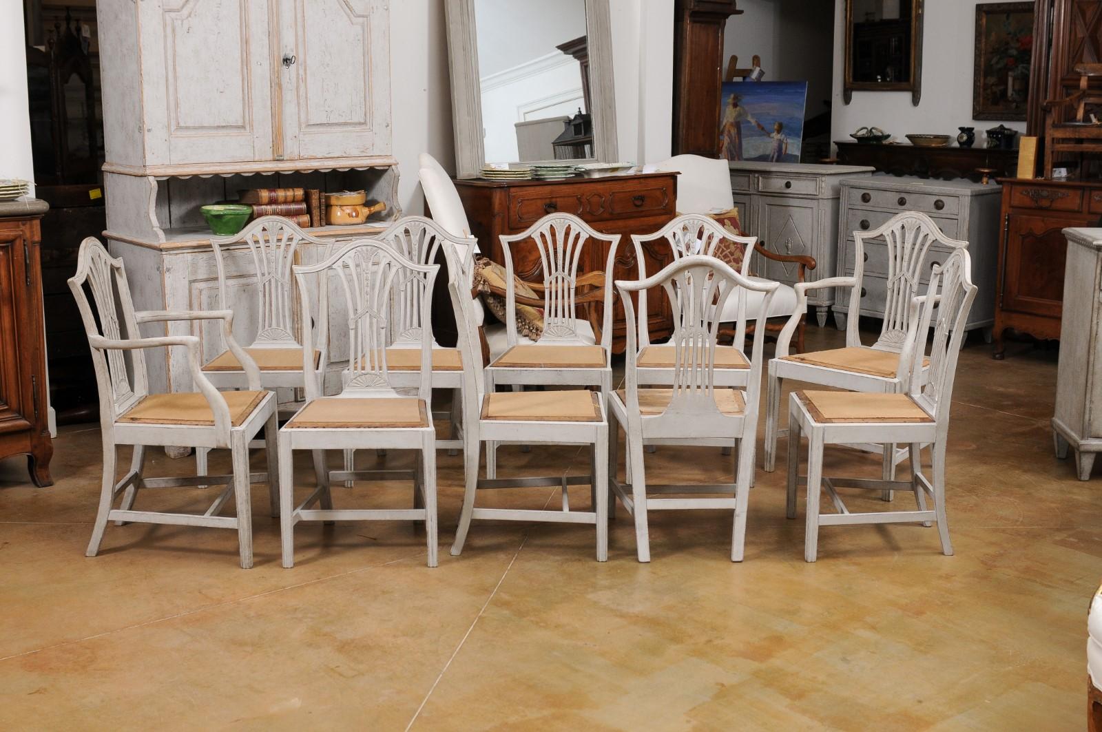 A set of 10 Swedish painted wood wheat back dining room chairs from the late 19th century, with two arms and eight sides. Created in Sweden during the last decade of the 19th century, each of this set of dining room chairs features an elegant