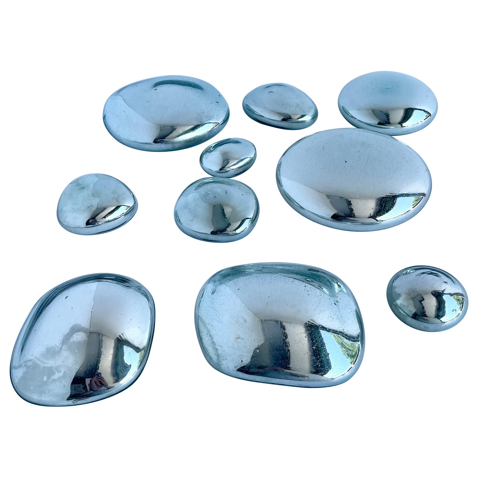 Vintage mercury glass wall sculpture collection. Polished and in a variety of sizes, the grouping of wall sculptures is composed of 10 orbital teardrop forms of varying sizes, resembling water droplets, executed in radiant mercury glass. Some of
