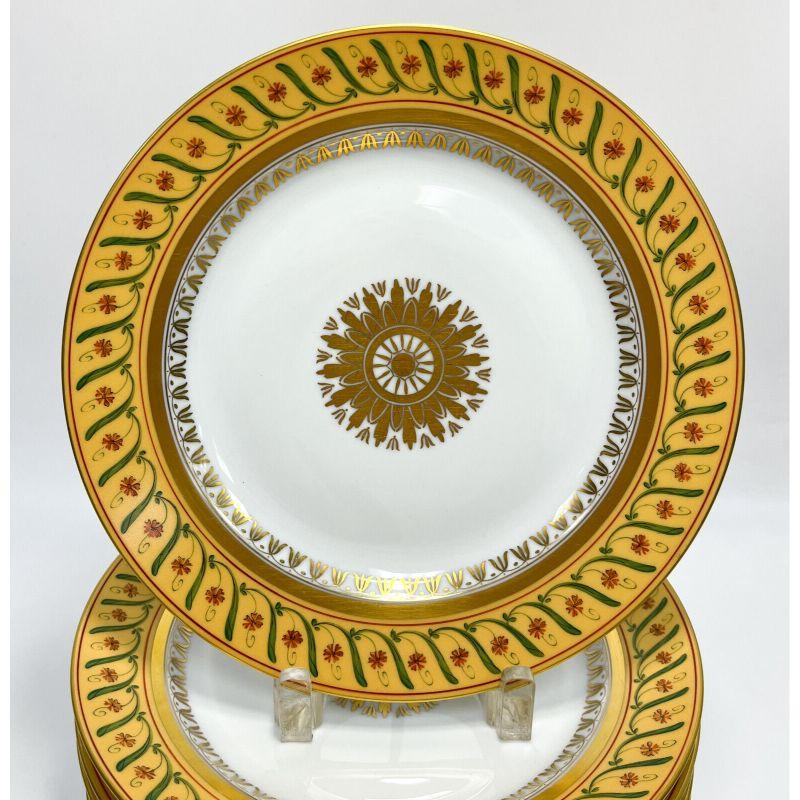 Set of 10 Tiffany Le Tallec private stock porcelain dinner plates in directoir

10 Tiffany Le Tallec Private Stock porcelain dinner plates in Directoir. A yellow ground with hand painted flowers and leaves throughout. Gilt florals to the center.