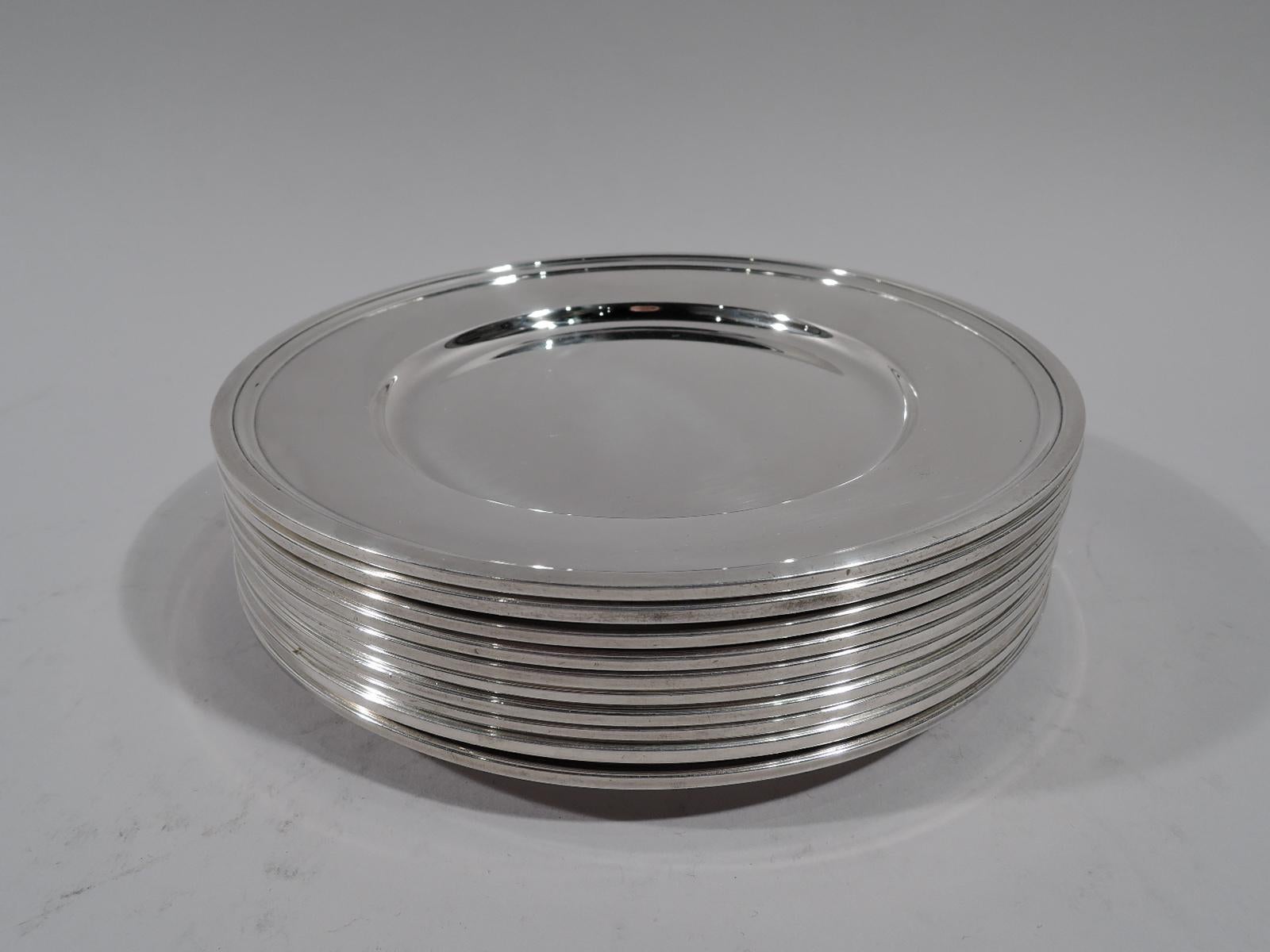 Set of 10 modern sterling silver bread and butter plates. Made by Tiffany & Co. in New York, circa 1923. Each: Deep well and molded rim. Fully marked. All have pattern no. 20198 (first produced in 1923). Eight have director’s letter m (1907-47) and