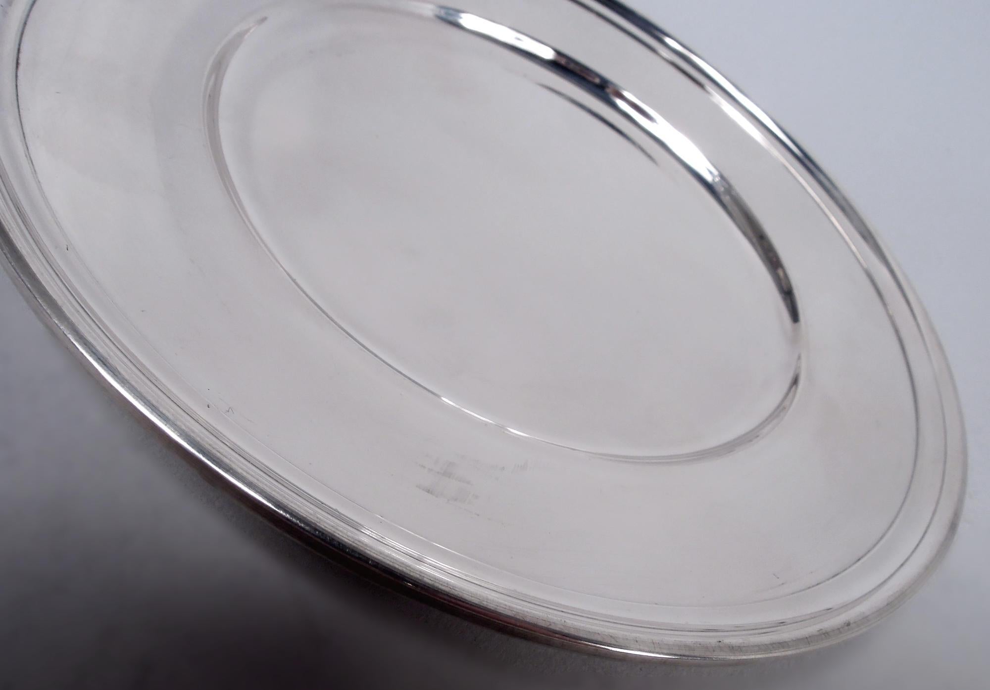 Set di 10 moderni piatti da pane e burro in argento sterling. Realizzato da Tiffany & Co. a New York. Ciascuno: Pozzo rotondo, spalla affusolata e bordo modellato. Completamente marcato con timbro del produttore e modello n. 20198 (prodotto per la