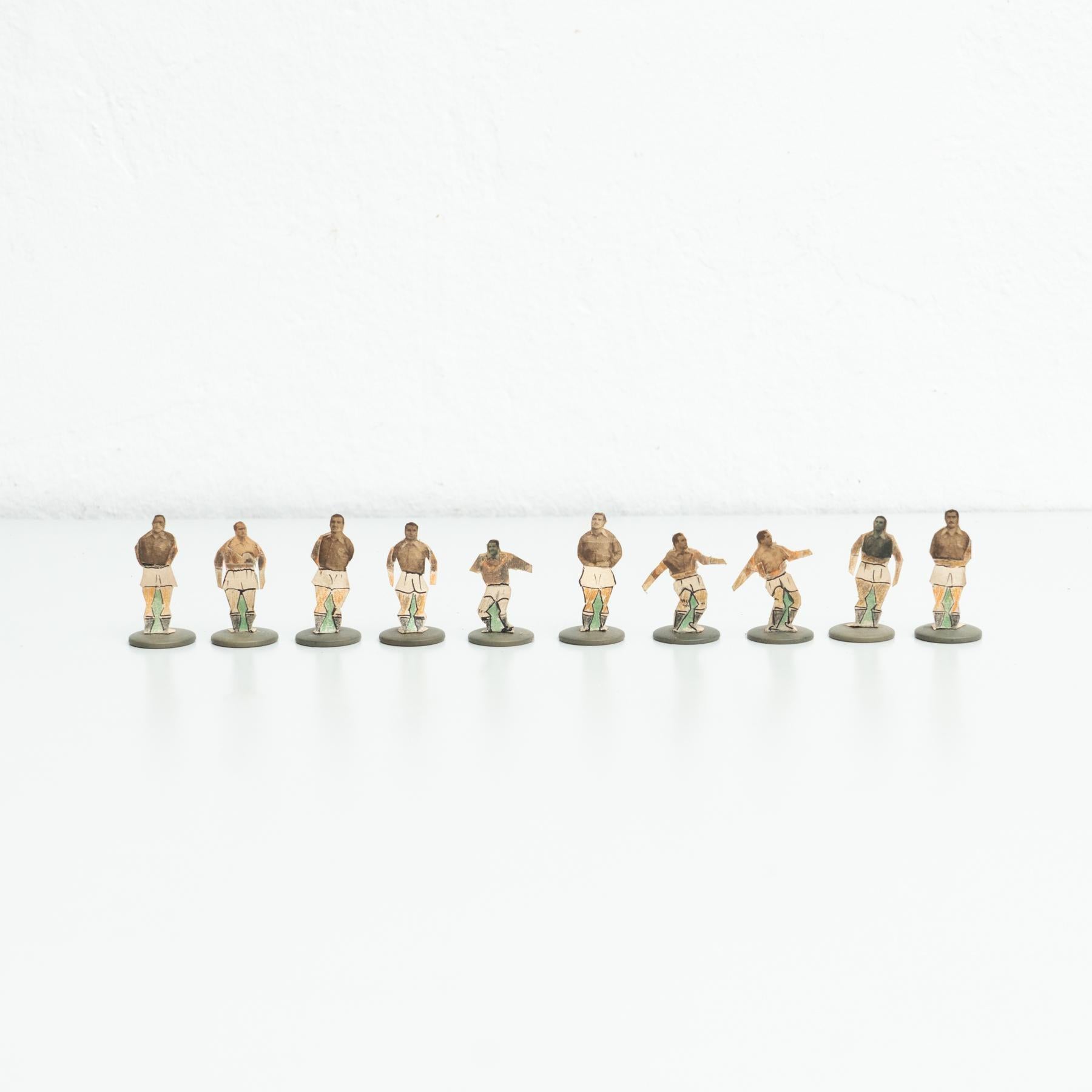 Set of ten table button soccer game players. Traditional figures used to play this classic button Spanish game.     Manufactured in Spain, circa 1950.    In original condition, with minor wear consistent with age and use, preserving a beautiful