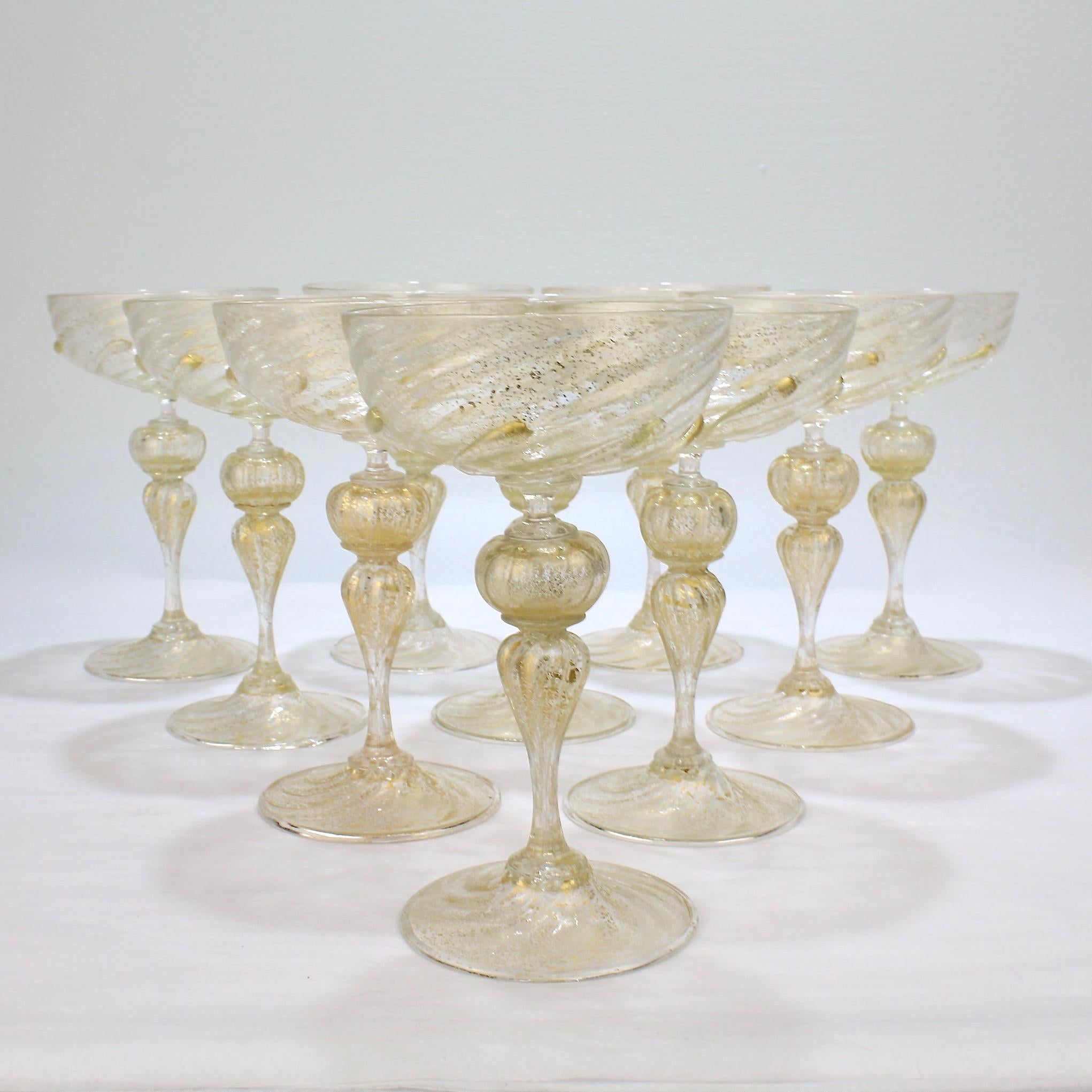 A vintage set of 10 Venetian or Murano glass champagne coupes.

Attributed to Salviati.

Finely worked with applied swirled prunts to the base of the cups and gold inclusions throughout.

A great form and of the finest quality.

Measure: