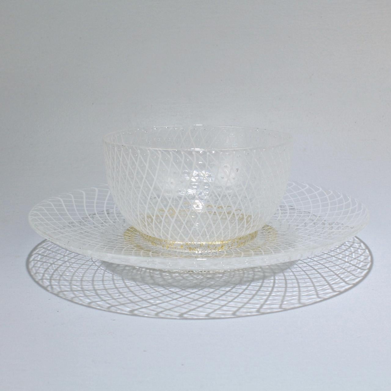 An elegant set of 10 Venetian glass bowls and underplates.

Attributed to Seguso.

Each piece is finely decorated in the reticulo filigrana technique (which consists of individual white glass rods in a diamond mesh pattern that is punctuated by