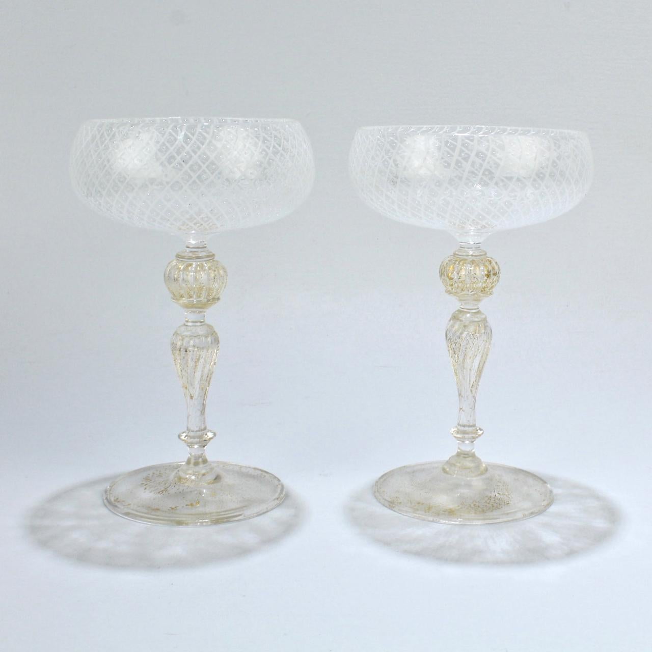 An elegant set of 10 Venetian glass champagne coupes.

Attributed to Seguso.

The bowl of each coupe is finely decorated in the reticulo filigrana technique (which consists of individual white glass rods in a diamond mesh pattern that is