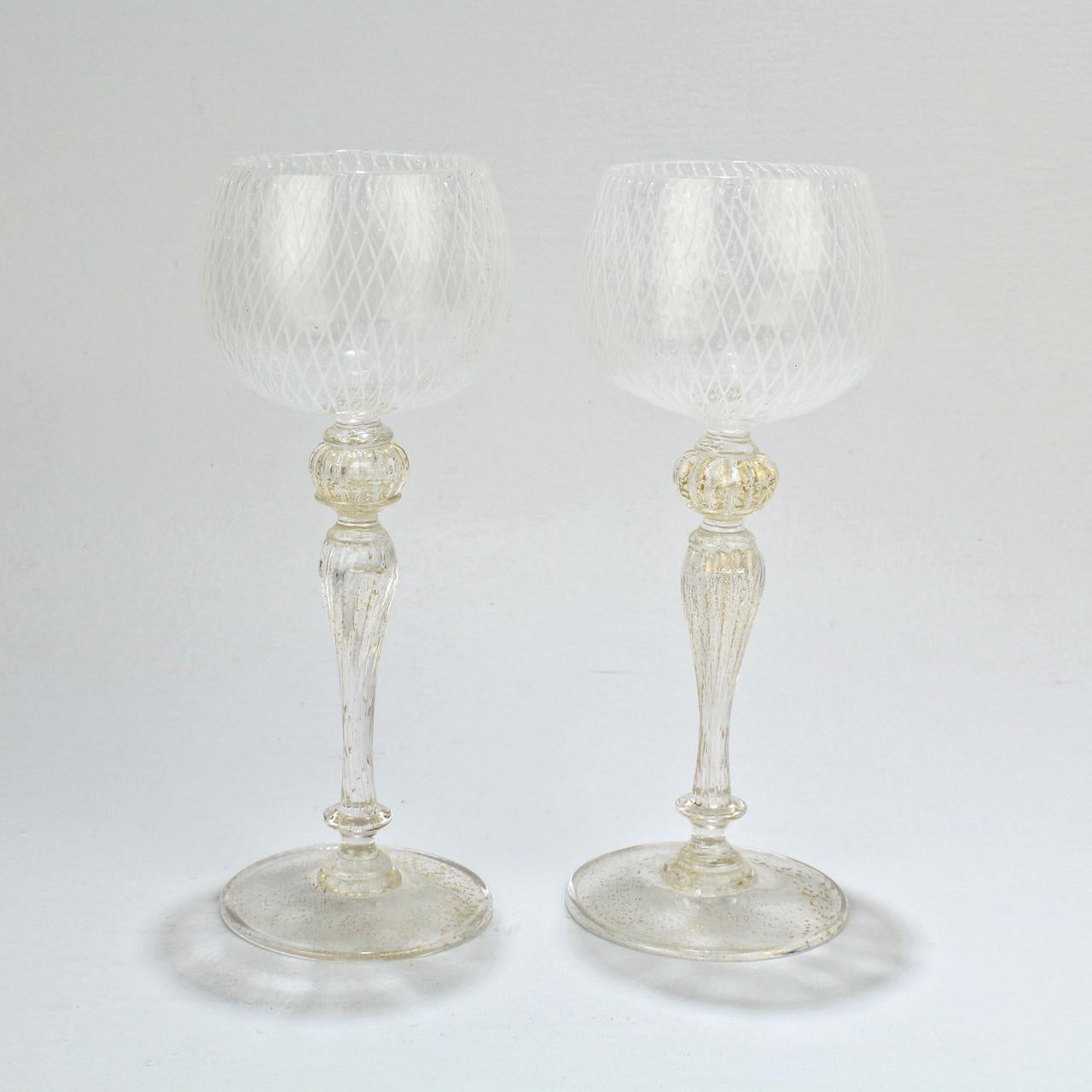 An elegant set of 10 Venetian glass wine glasses.

Attributed to Seguso.

The bowl of each goblet is finely decorated in the reticulo filigrana technique (which consists of individual white glass rods in a diamond mesh pattern that is punctuated