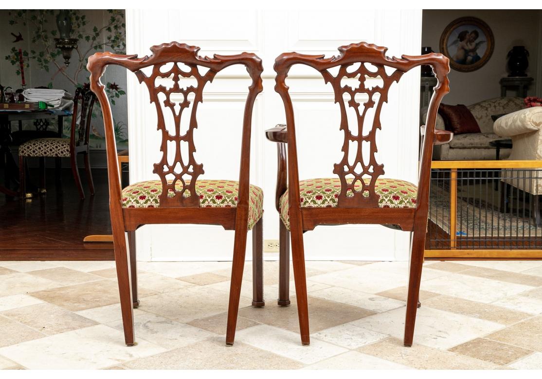 Set of ten Chippendale style dining chairs. With Classic Chippendale elaborate leafy carved details and openwork splats. The seats upholstered in a red on green floral cut velvet.
Set includes: 
Measures : Arm Chairs (2): 24 1/2